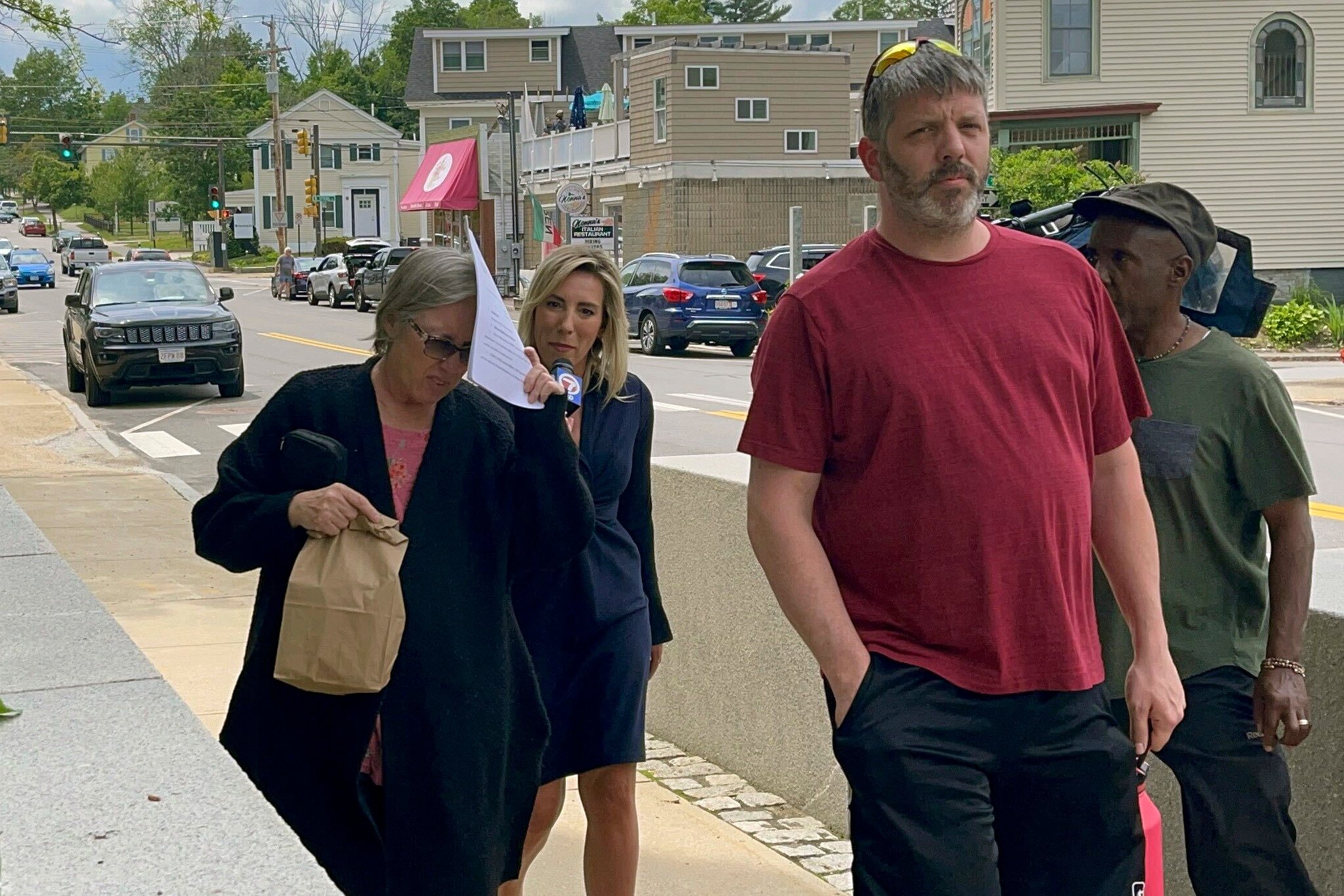 Denise Lodge, left, covers her face as she walks from the courthouse in Concord, New Hampshire on Wednesday following her arrest on charges related to an alleged scheme to steal and sell body parts. Photo: The Boston Globe via AP