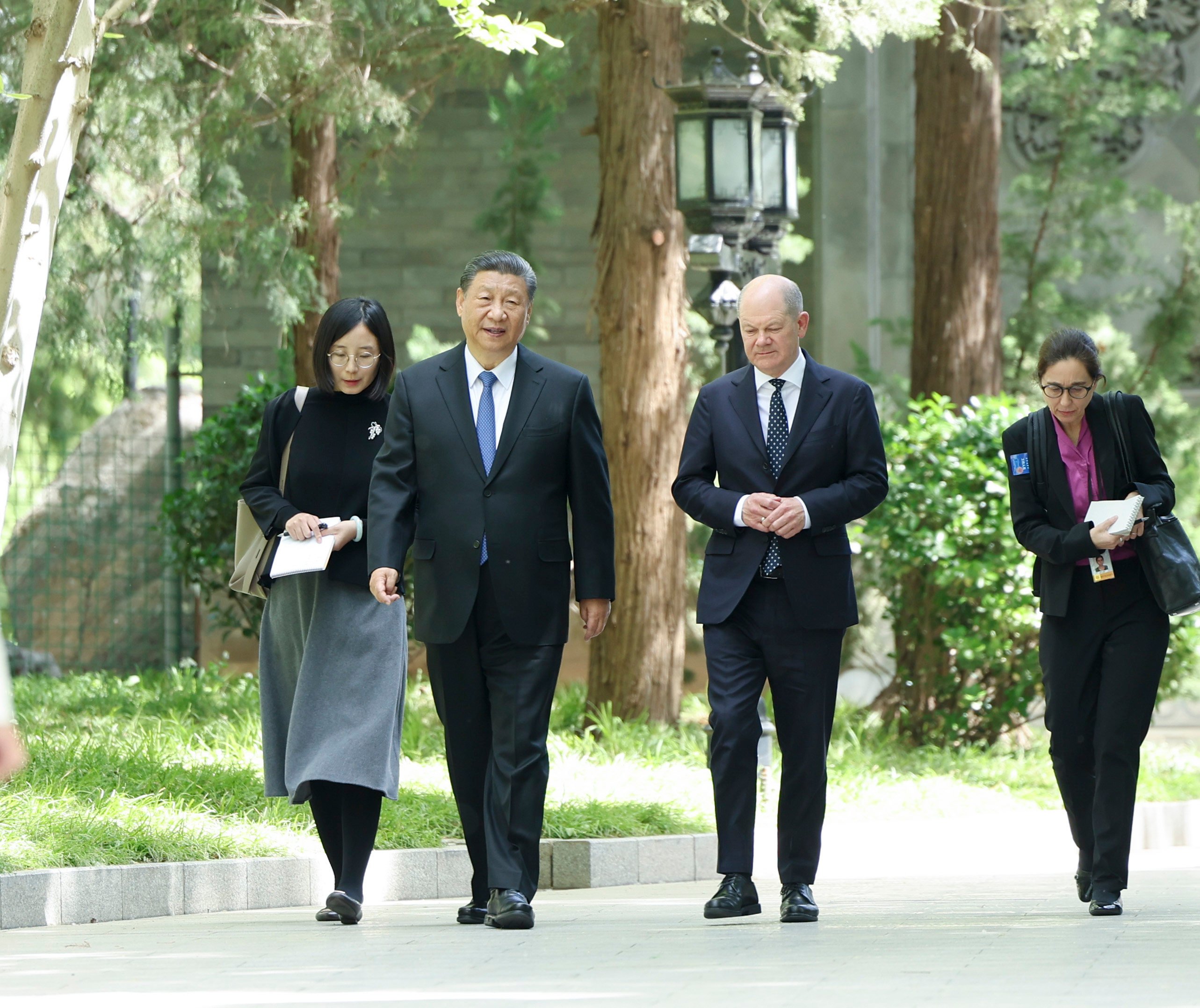 Xi Jinping and Olaf Scholz pictured strolling through the grounds of the Diaoyutai State Guesthouse in Beijing on Tuesday. Photo: Xinhua
