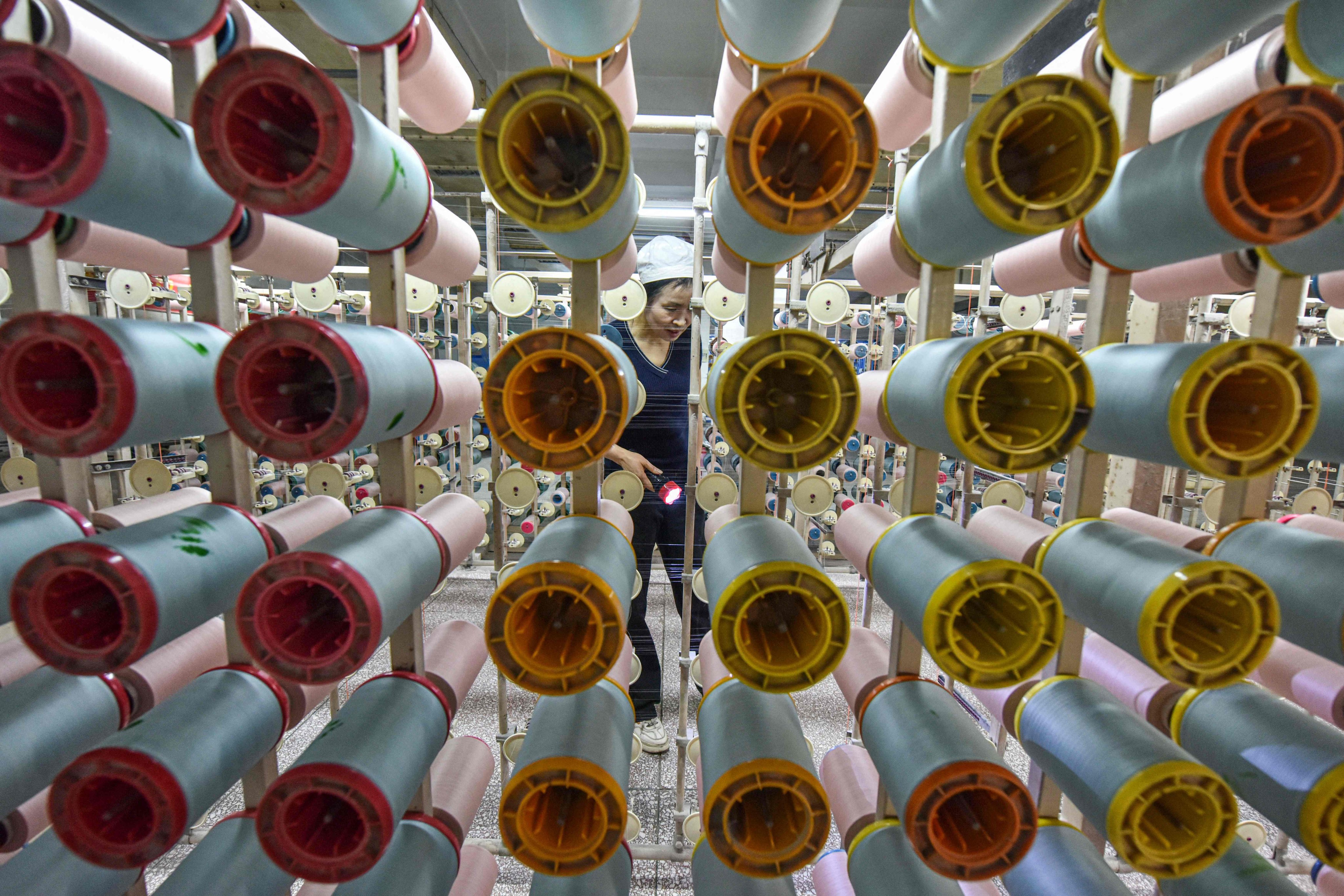 A worker produces silk products at a textile factory in Anhui province on Tuesday, when some analysts shared concerns that China’s economic recovery may rely too heavily on manufacturing. Photo: AFP