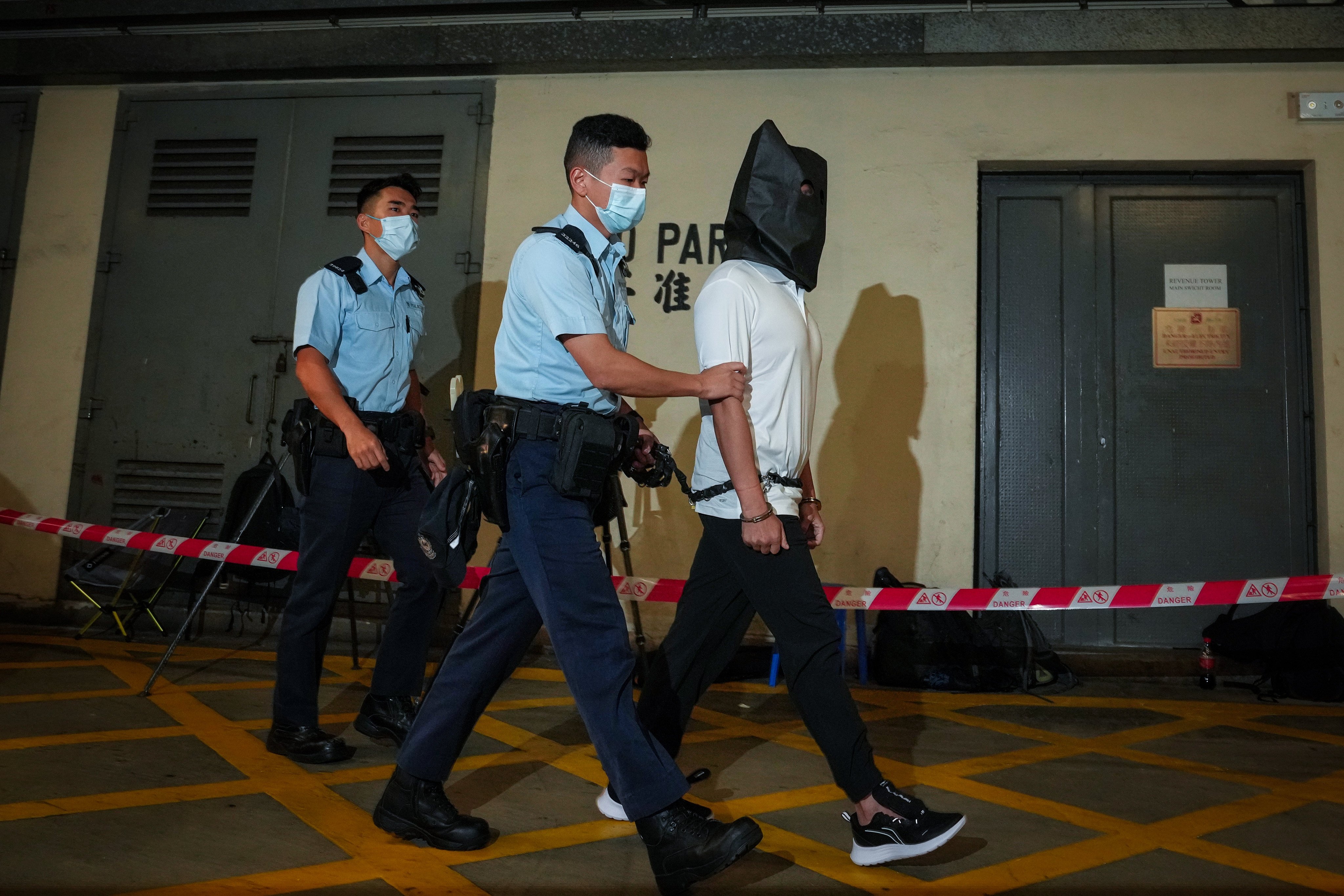 Tang Kai-yin, who has been jailed for 46 months, is escorted to court for an earlier appearance on charges of making petrol bombs and attempting to avoid justice by fleeing to Taiwan. Photo: Elson Li