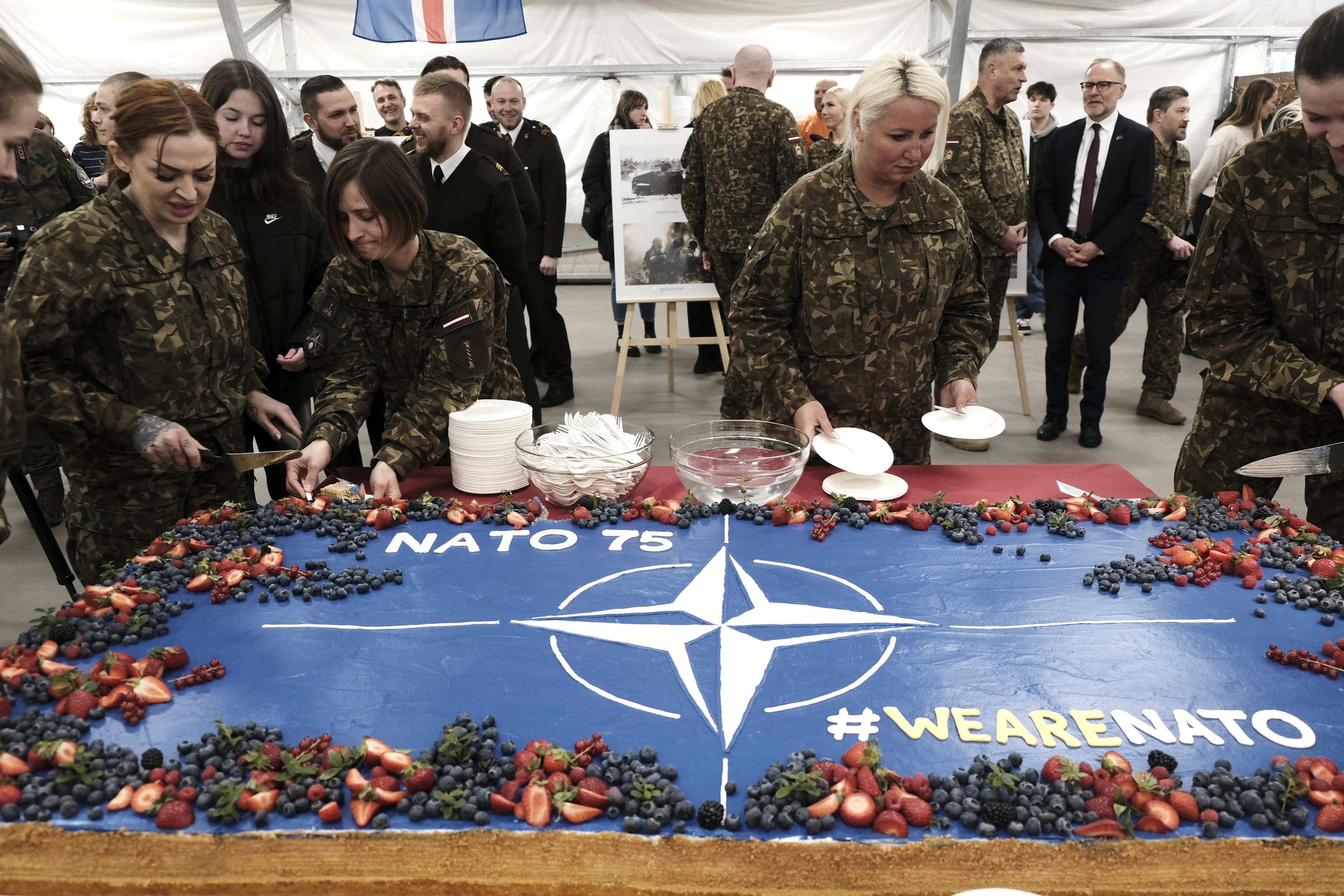 Soldiers prepare slices of a celebration cake during a ceremony marking the 75th anniversary of Nato at the Adazi military base near Riga, Latvia, on April 4. The North Atlantic Treaty Organization now has 32 member states. Photo: EPA-EFE