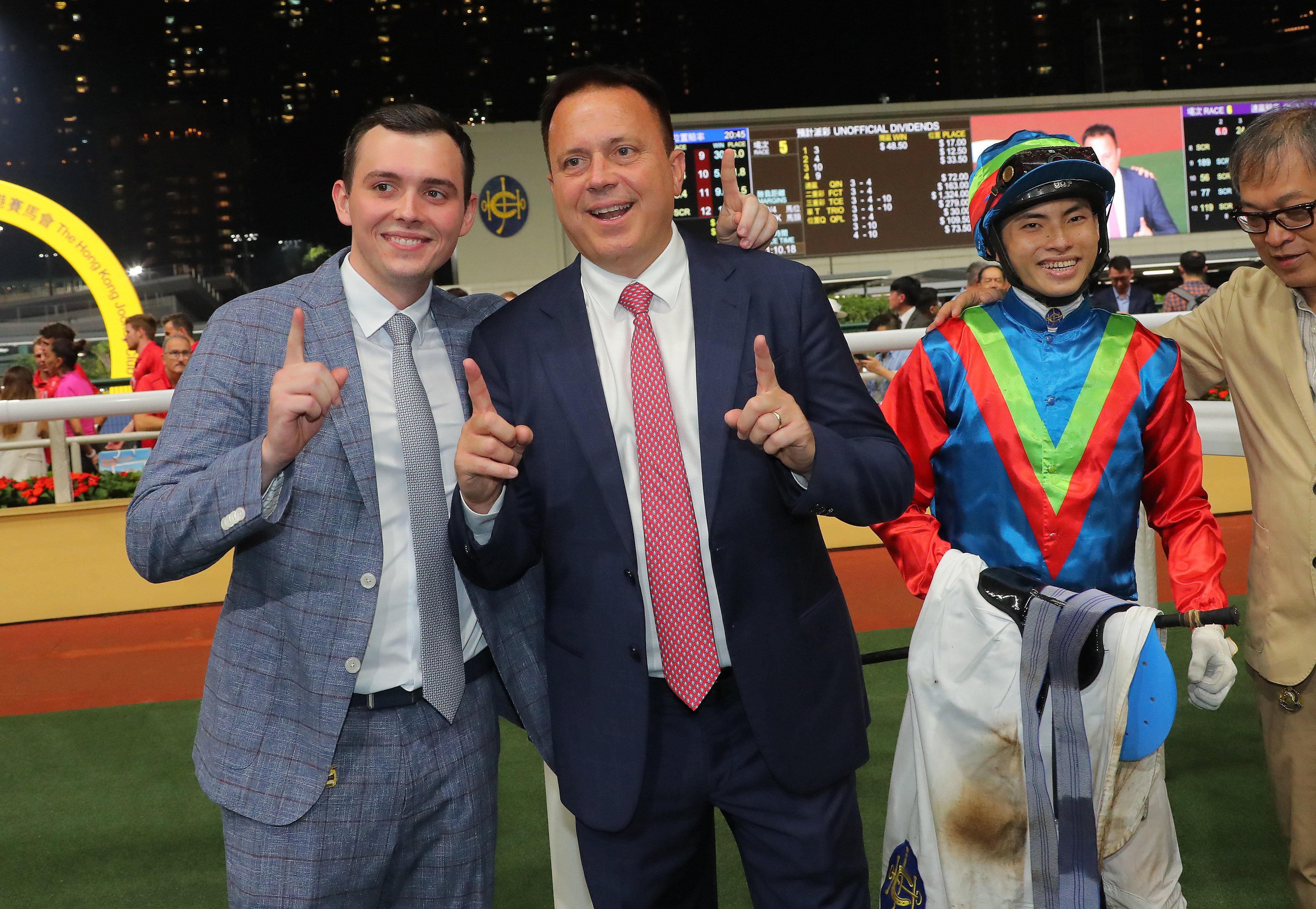 Caspar Fownes (centre) celebrates his 1,100th Hong Kong win with son Ronan (left) and Ellis Wong at Happy Valley. Photos: Kenneth Chan