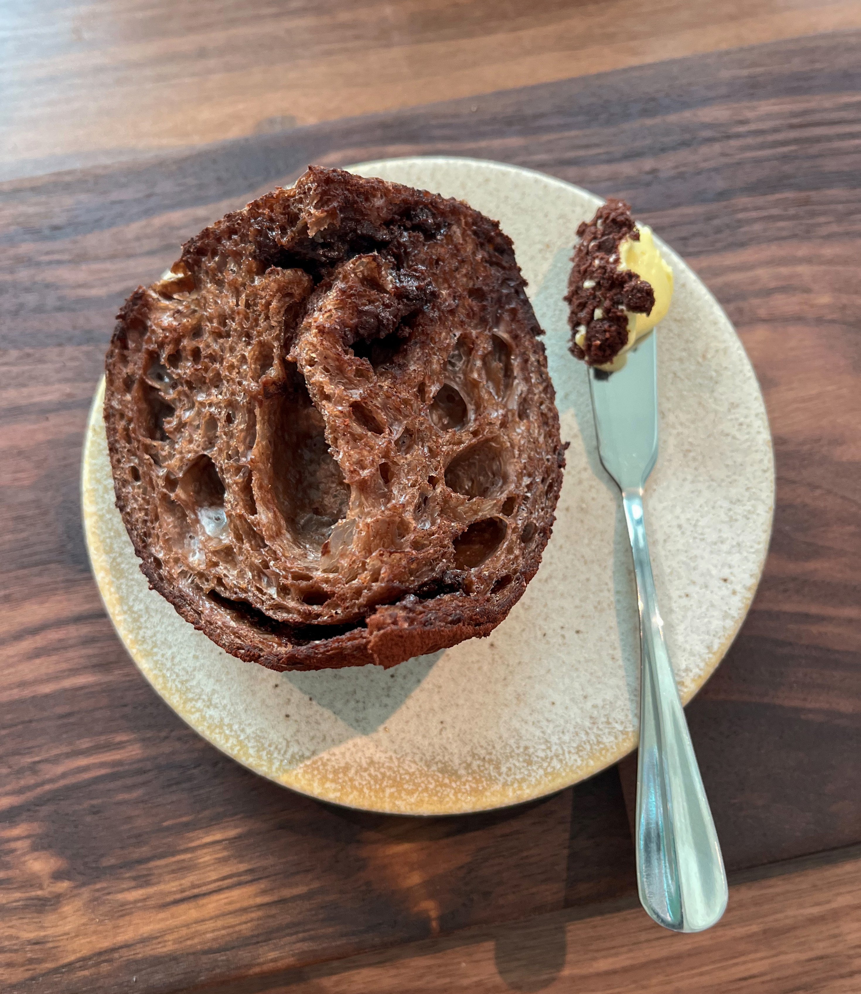 Chocolate sourdough served with a miso crumble and garlic butter is an unusual but successful combination at Otera. SCMP/Charmaine Mok