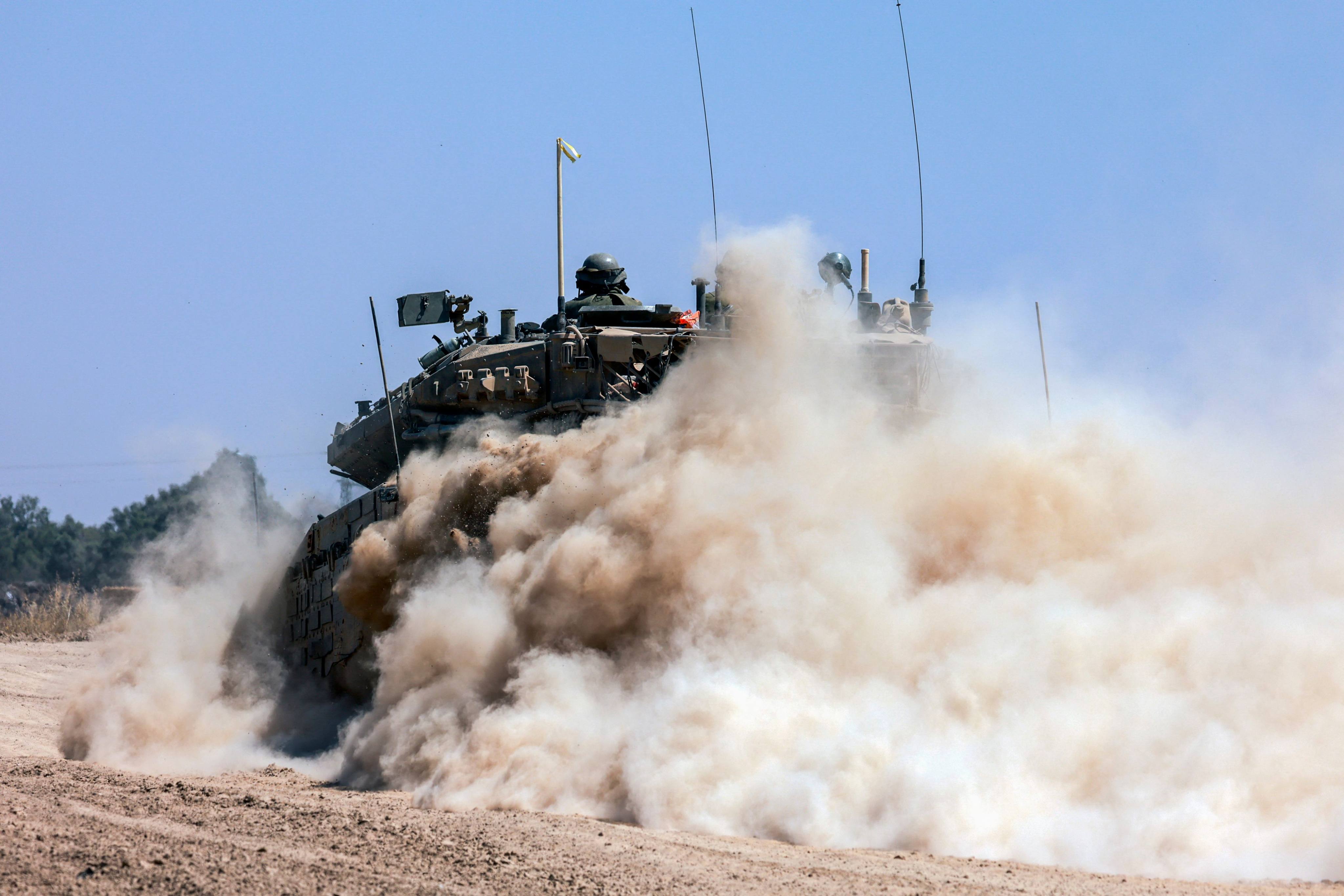 An Israeli tank rolls along the border with the Gaza Strip on Tuesday. Photo: AFP