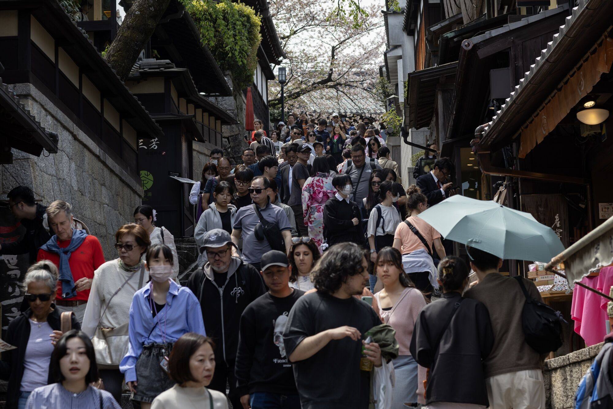 Visitors walk along the Sannenzaka approach in Kyoto, Japan, on Saturday. For the first time ever, Japan welcomed 3 million tourists in a month. Photo: Bloomberg