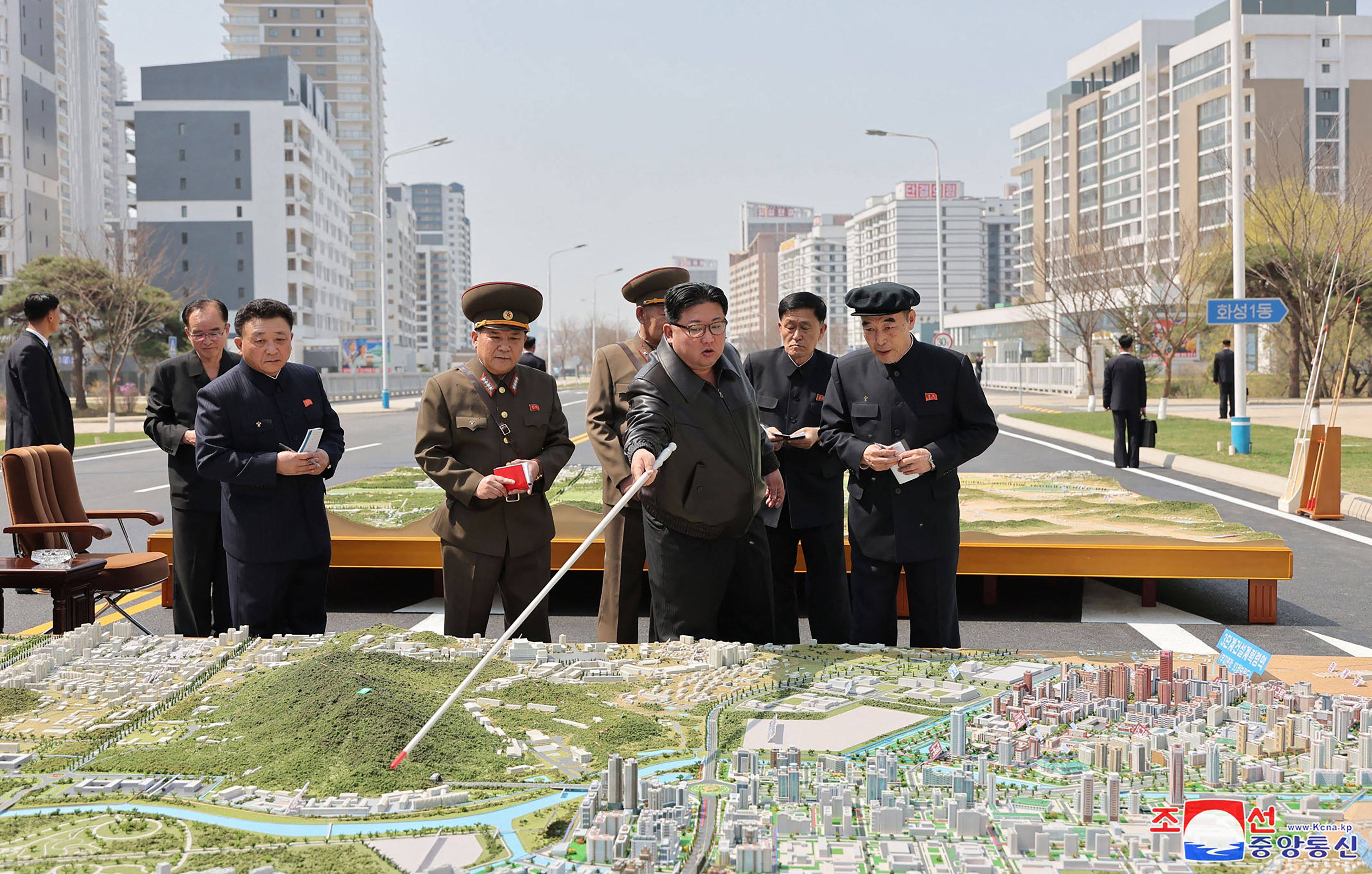 North Korea’s leader Kim Jong Un (centre) inspecting the diorama of a second phase of 10,000 houses in a district of Pyongyang earlier in April Photo: KCNA via KNS / AFP