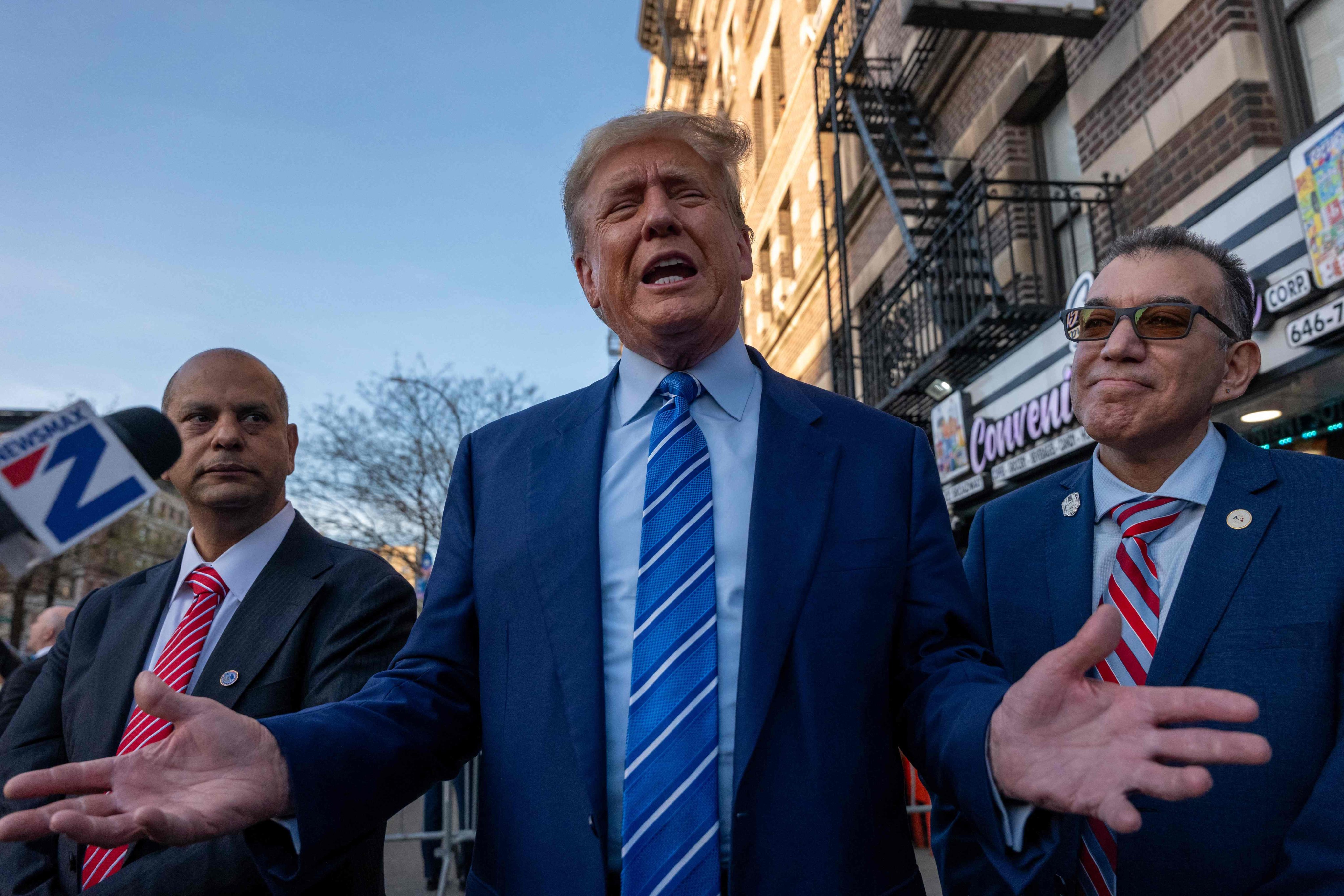 Donald Trump speaks to the media as he visits a bodega store in New York on Tuesday. Photo: AFP