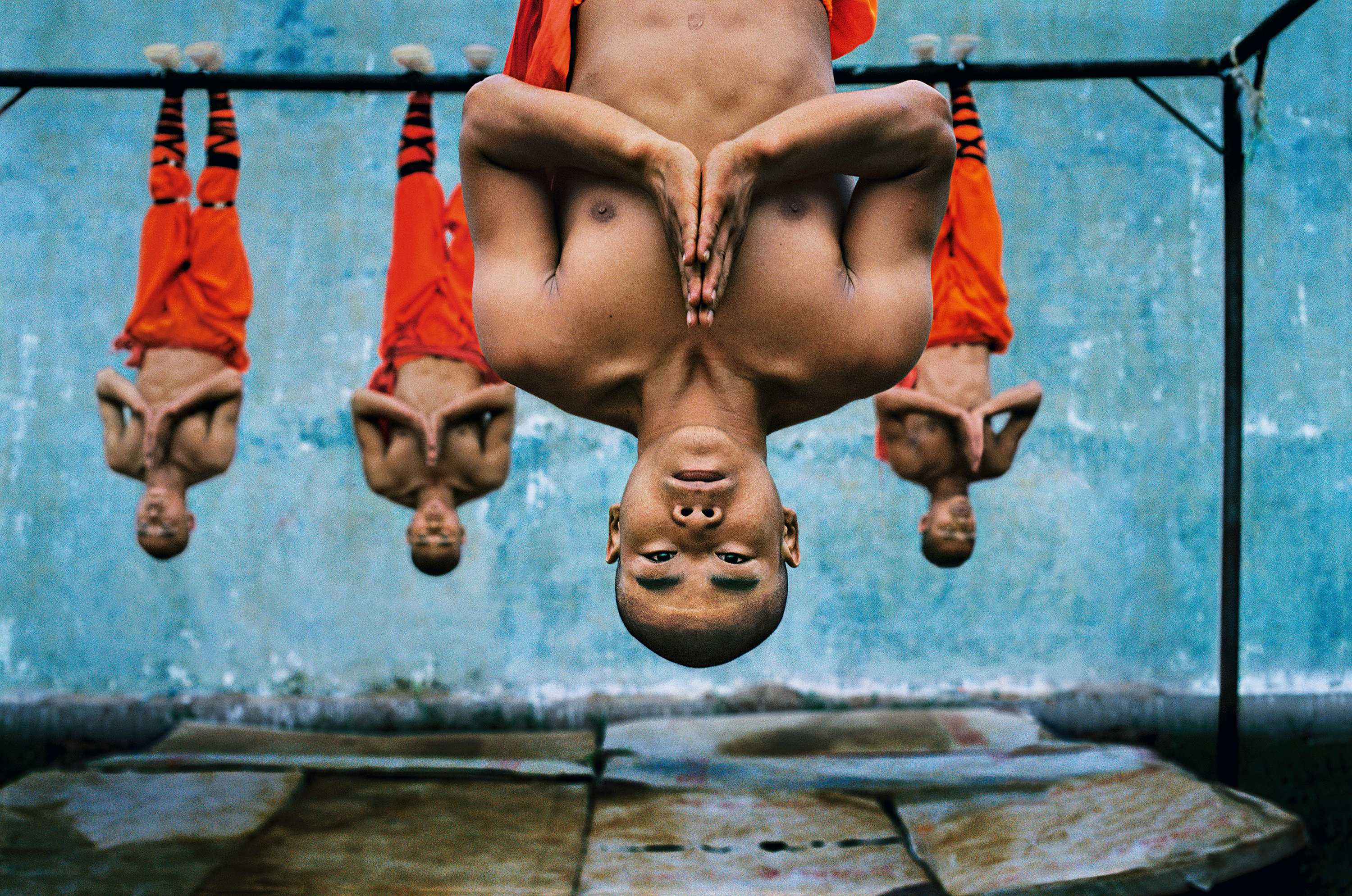 Steve McCurry’s photograph of monks suspended from a metal beam at the  Shaolin Monastery, in China, features in his new book, Devotion. The photographer talks about why he’s interested in human behaviour, and remaining respectful to gain access to sacred situations. Photo: Steve McCurry