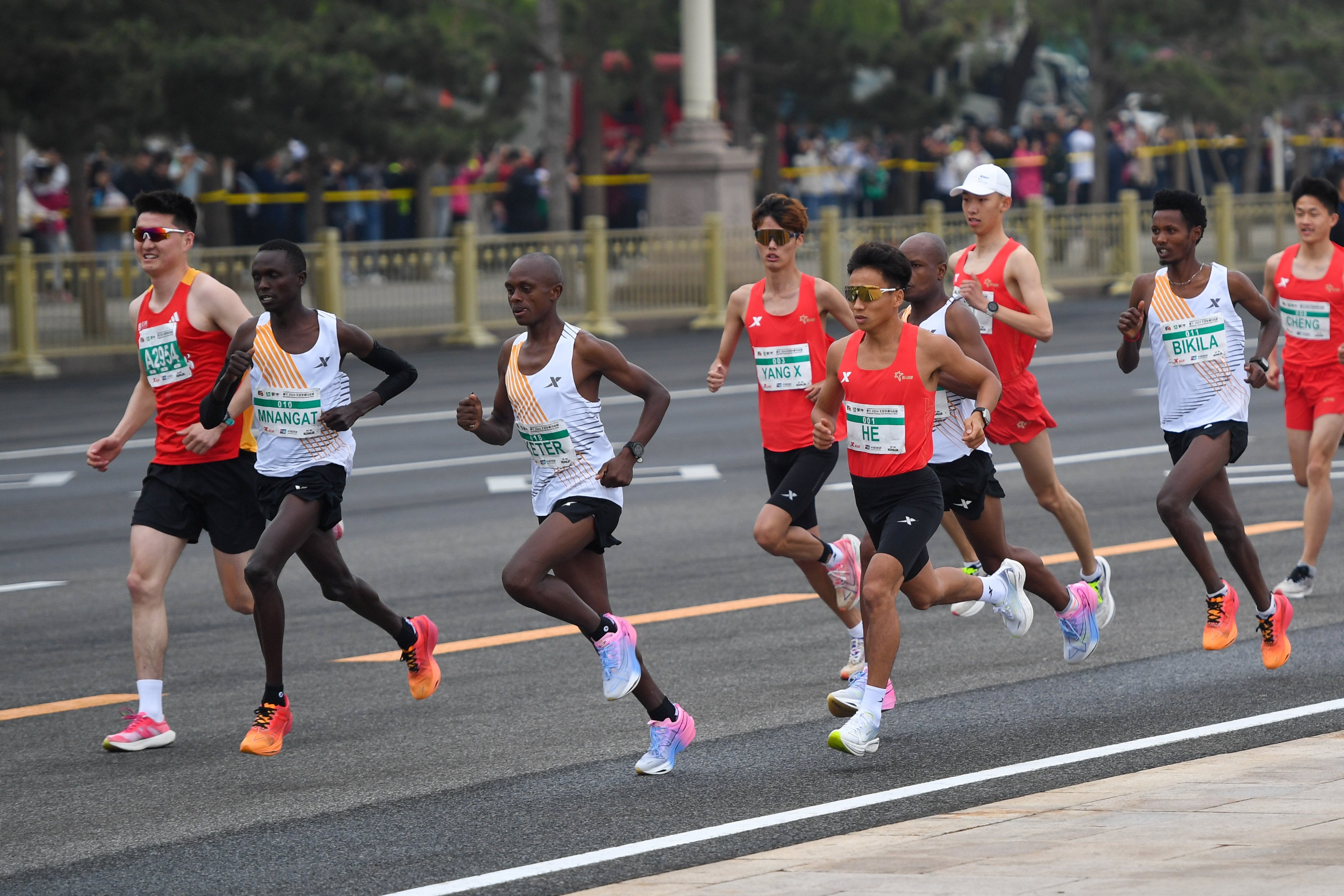 He Jie (fifth from left) crossed the line first at the Beijing Half Marathon last Sunday. Photo: Xinhua