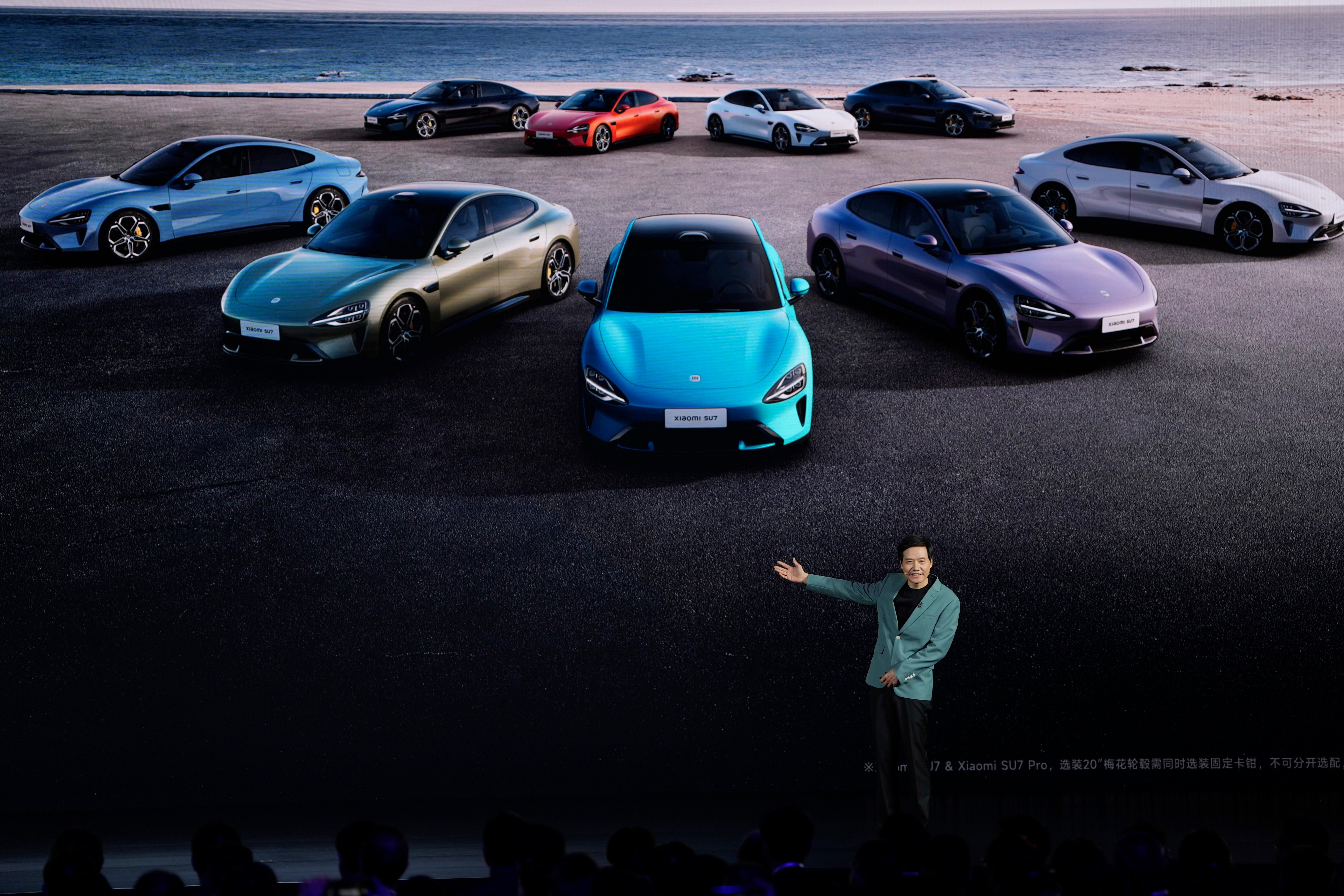 Xiaomi founder Lei Jun shows off the multiple colours of the SU7, a sporty four-door electric vehicle, during a launch event in Beijing, on March 28. Photo: AP 