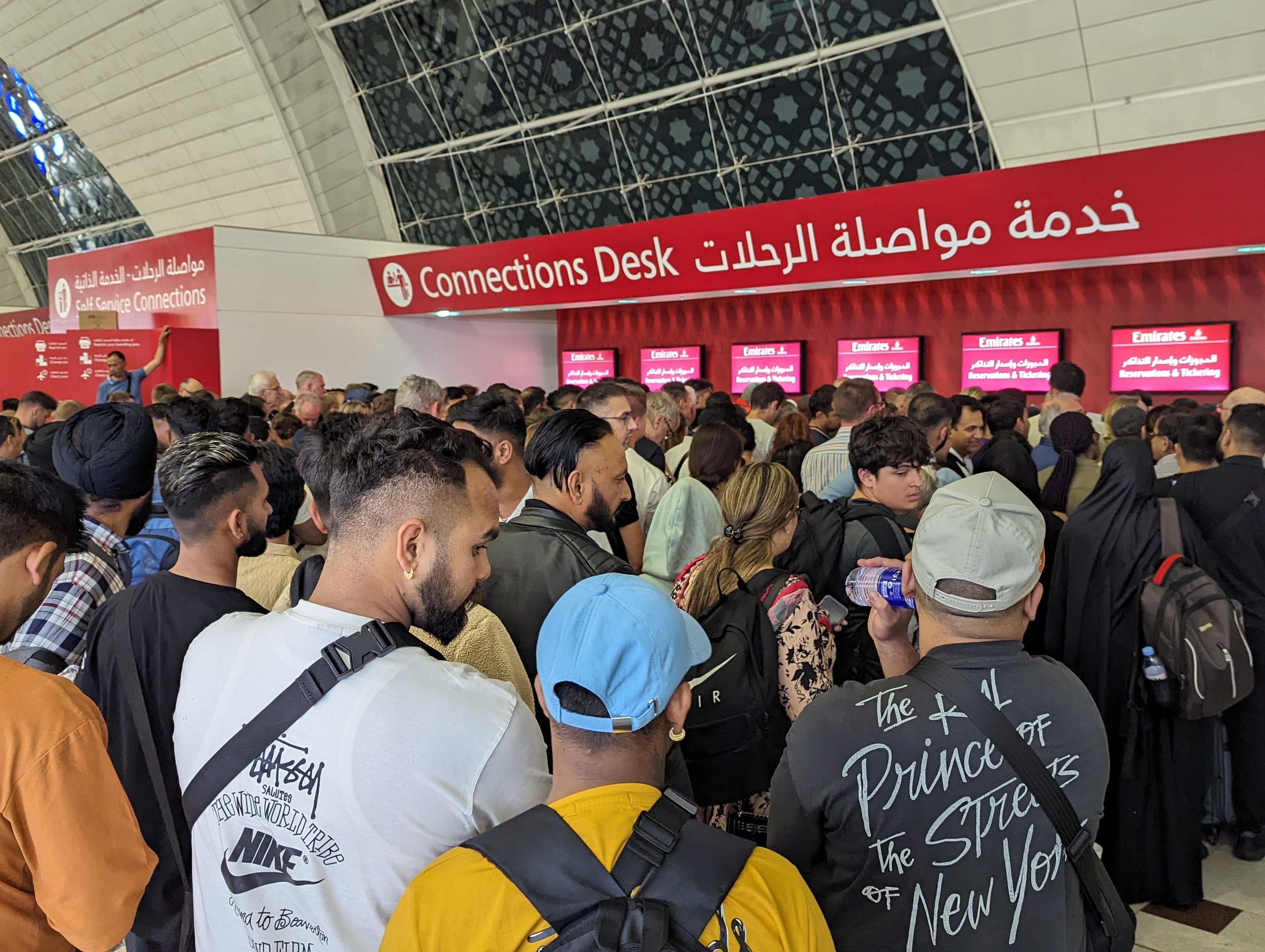 Stranded passengers search for information at Dubai International Airport on April 19, 2024, after more than 1,200 flights were cancelled following an unprecedented storm, leading to widespread travel chaos. Photo: Kevin Kwong