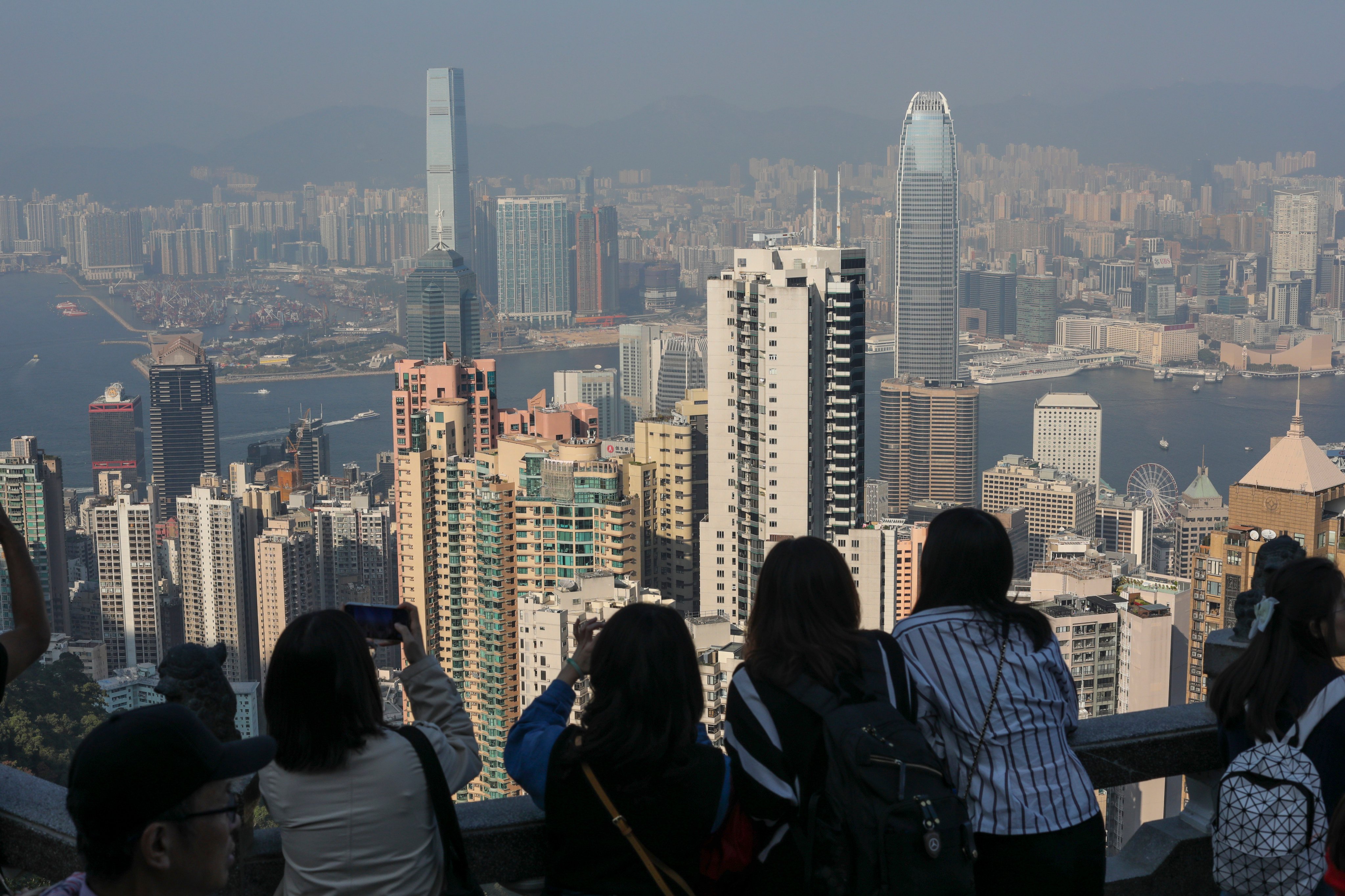 Tourists take in the view of Victoria Harbour from The Peak on January 6, 2024. Photo: Xiaomei Chen
