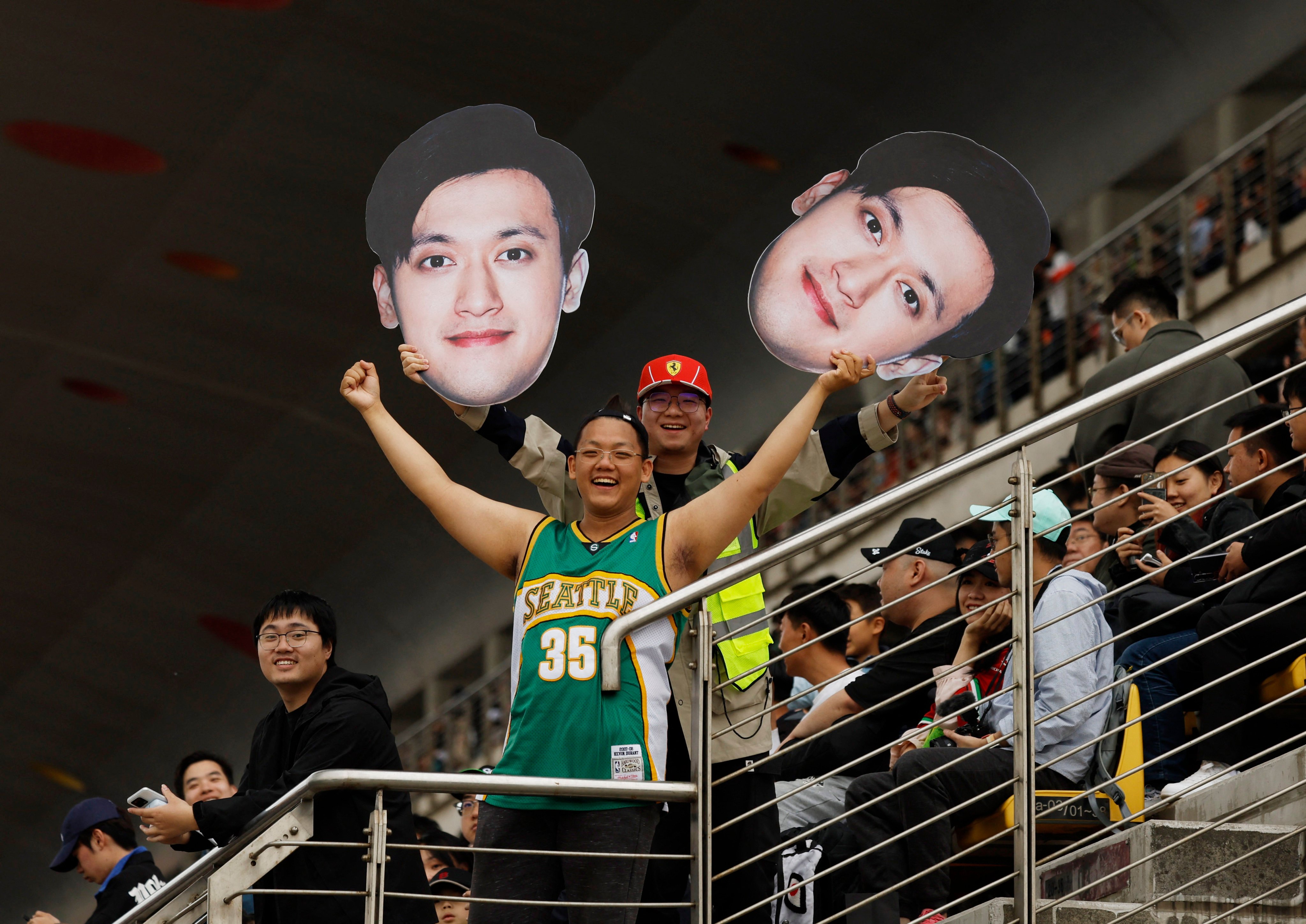 Fans in the stands hold up a cut-out of Sauber’s hometown hope Guanyu Zhou during the sprint qualifying session of the Chinese Grand Prix. Photo: Reuters