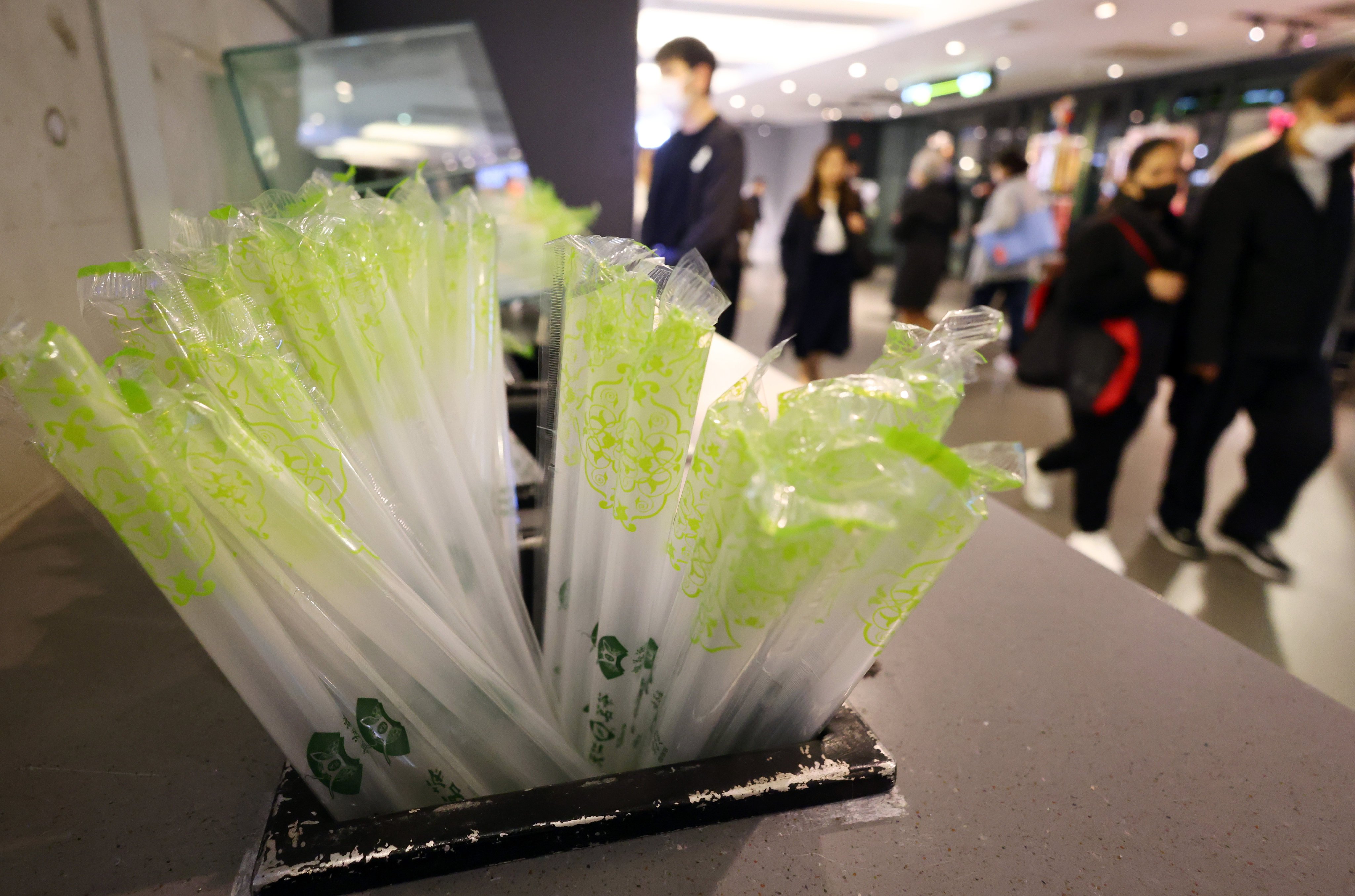 People walk past single-use straws at a take-away counter at a mall in Admiralty on January 24. The distribution of such items is no longer permitted. Photo: Dickson Lee