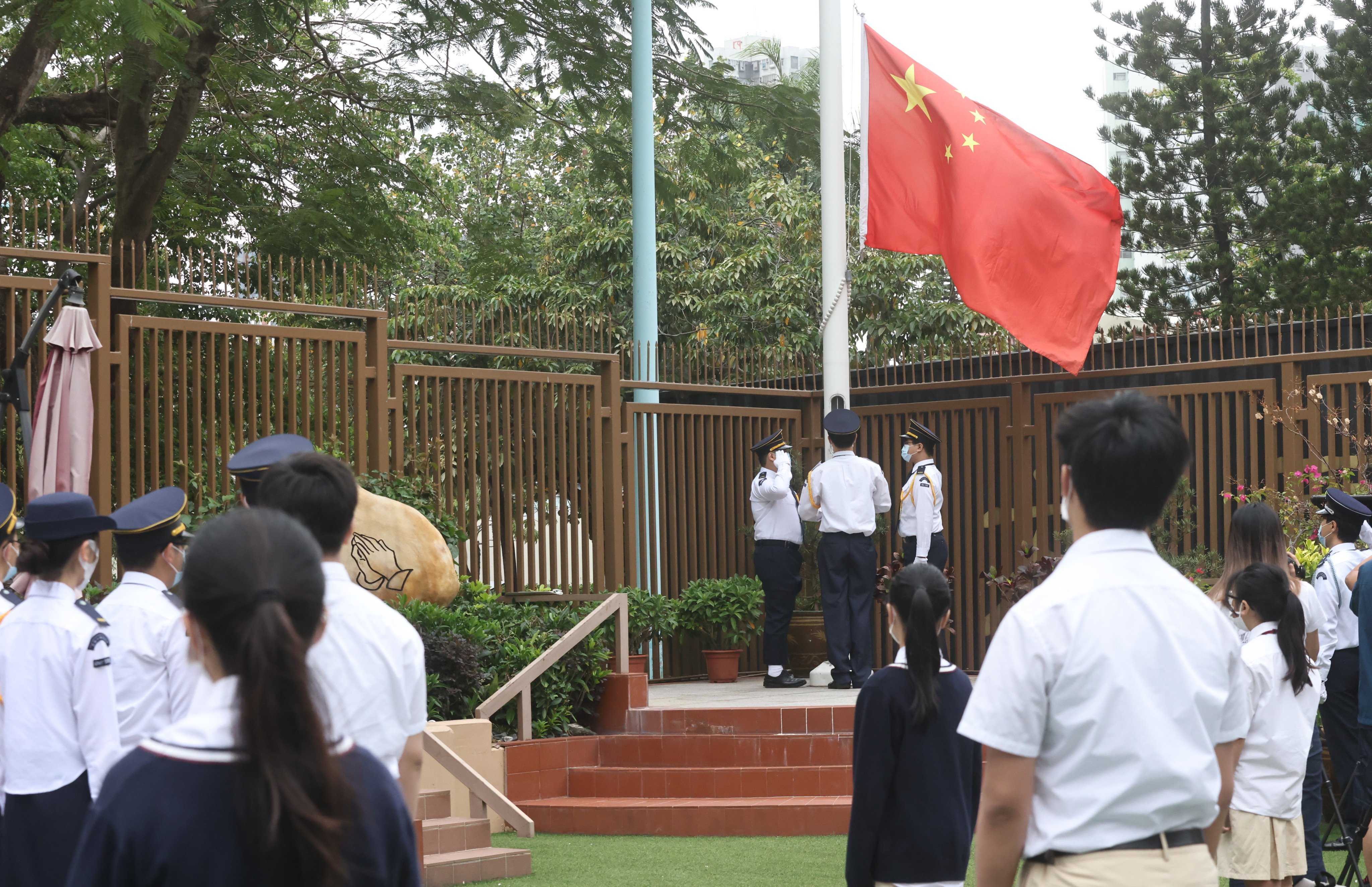 Students at Gertrude Simon Lutheran College attend a flag-raising ceremony during National Security Education Day earlier this week. Photo: K. Y. Cheng