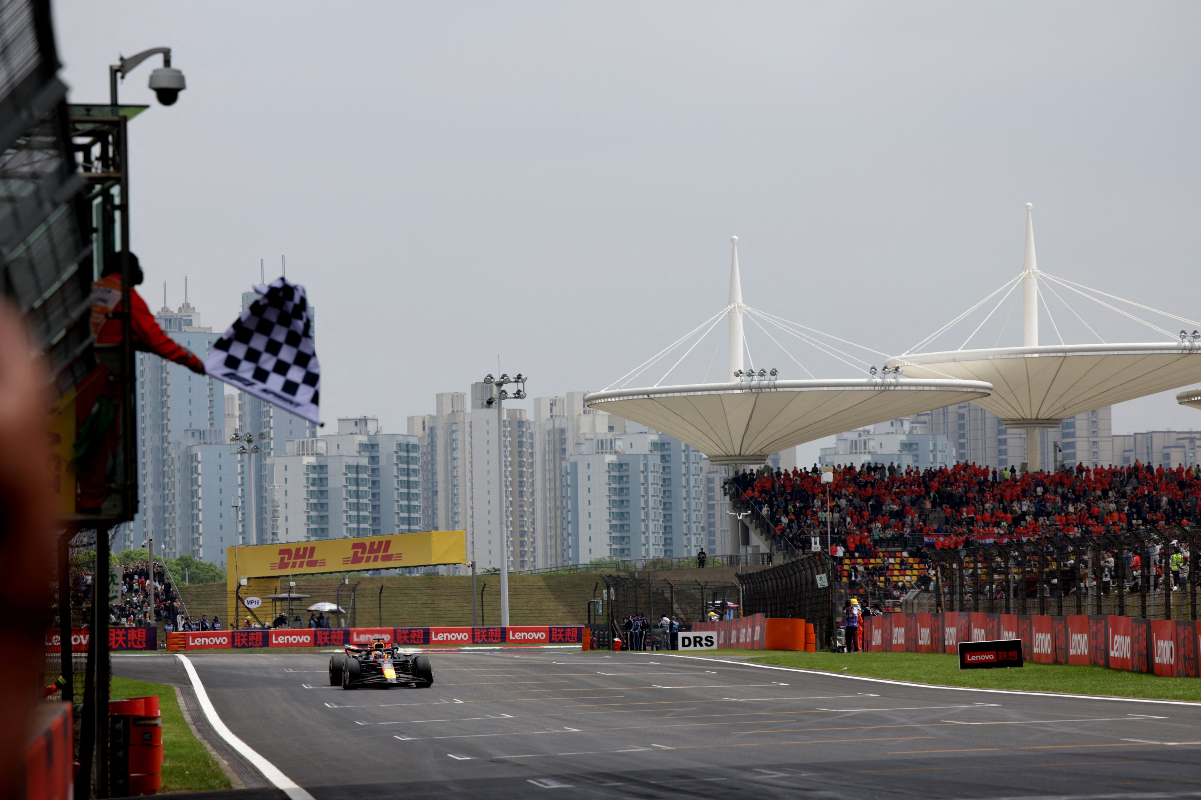 Red Bull’s Max Verstappen takes the chequered flag to win the sprint race at the Chinese Grand Prix. Photo: Reuters