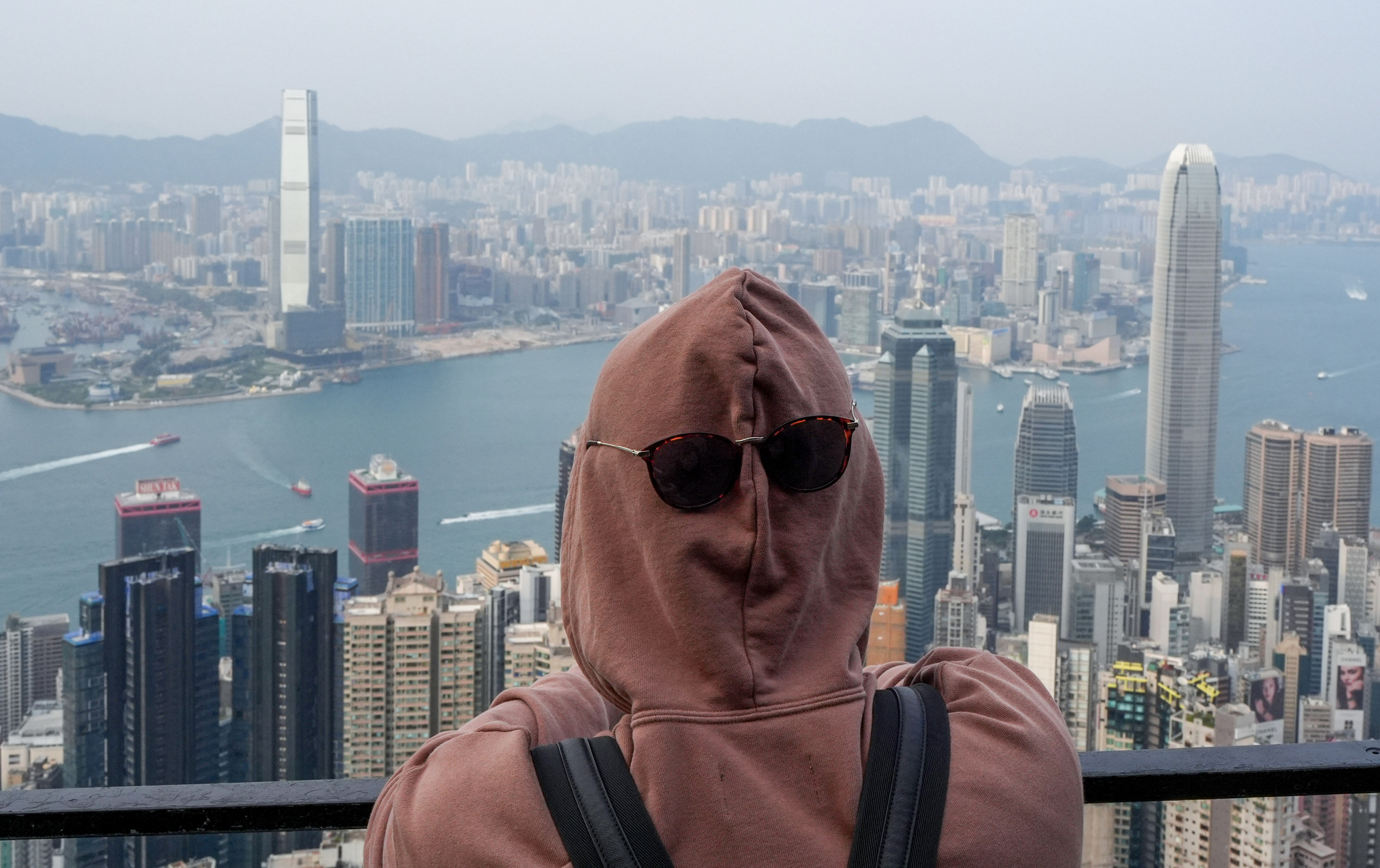 A tourist views the Hong Kong skyline at The Peak on a Monday afternoon. File photo: Eugene Lee