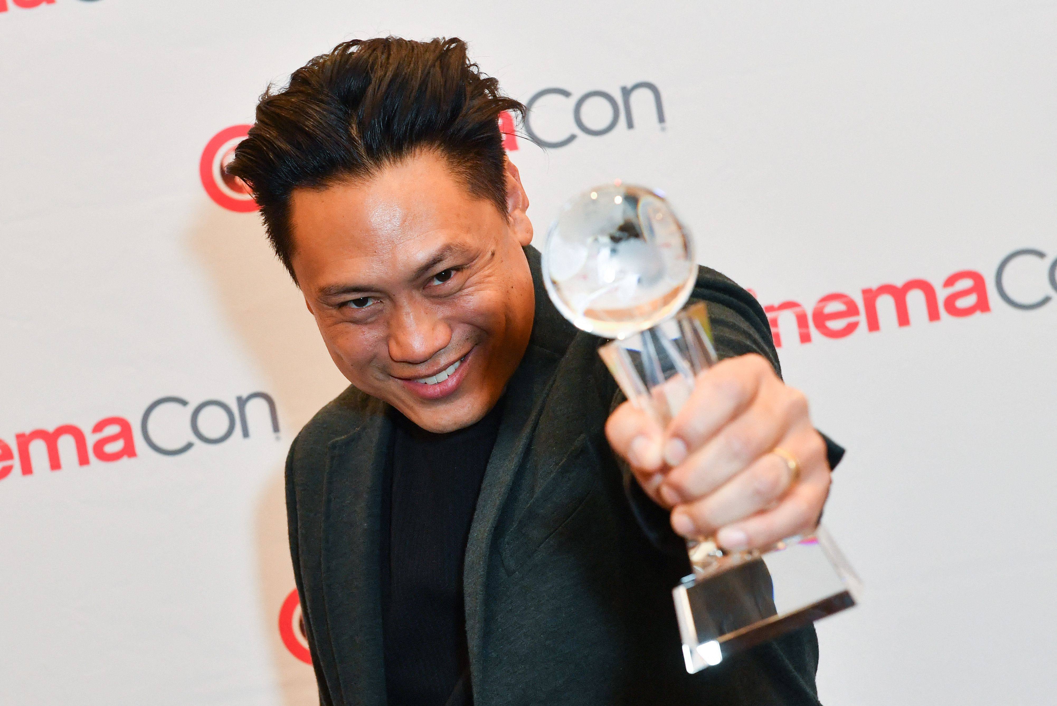 Director Jon M. Chu, recipient of the Martin Scorsese Legend Of Cinema Award, poses with the trophy during CinemaCon 2024 in Las Vegas on April 11. Photo: AFP