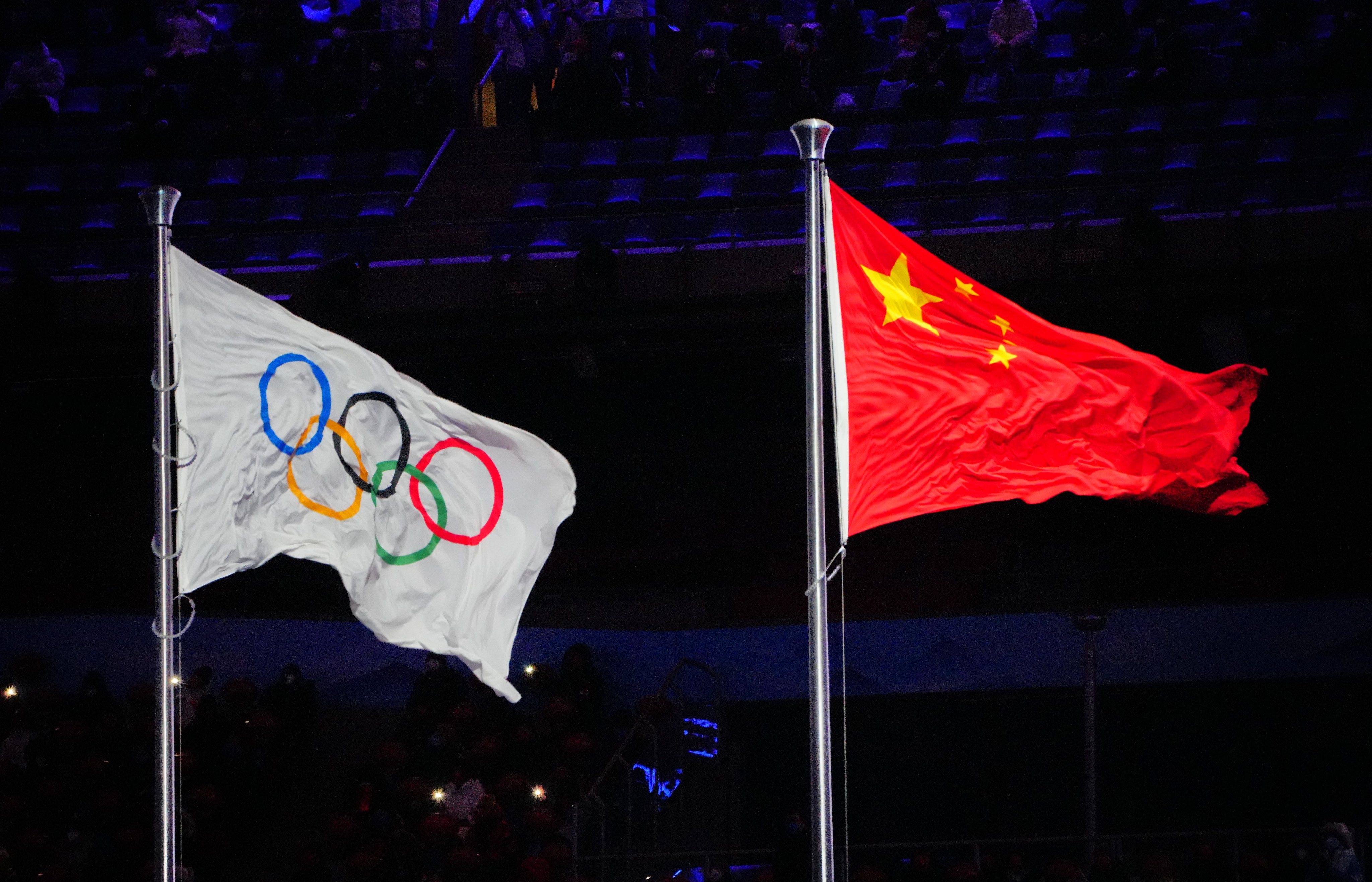 The flag of China and the Olympic flag flutter on their masts during the closing ceremony of the Beijing 2022 Winter Olympic Games at the Bird’s Nest National Stadium. Photo: DPA