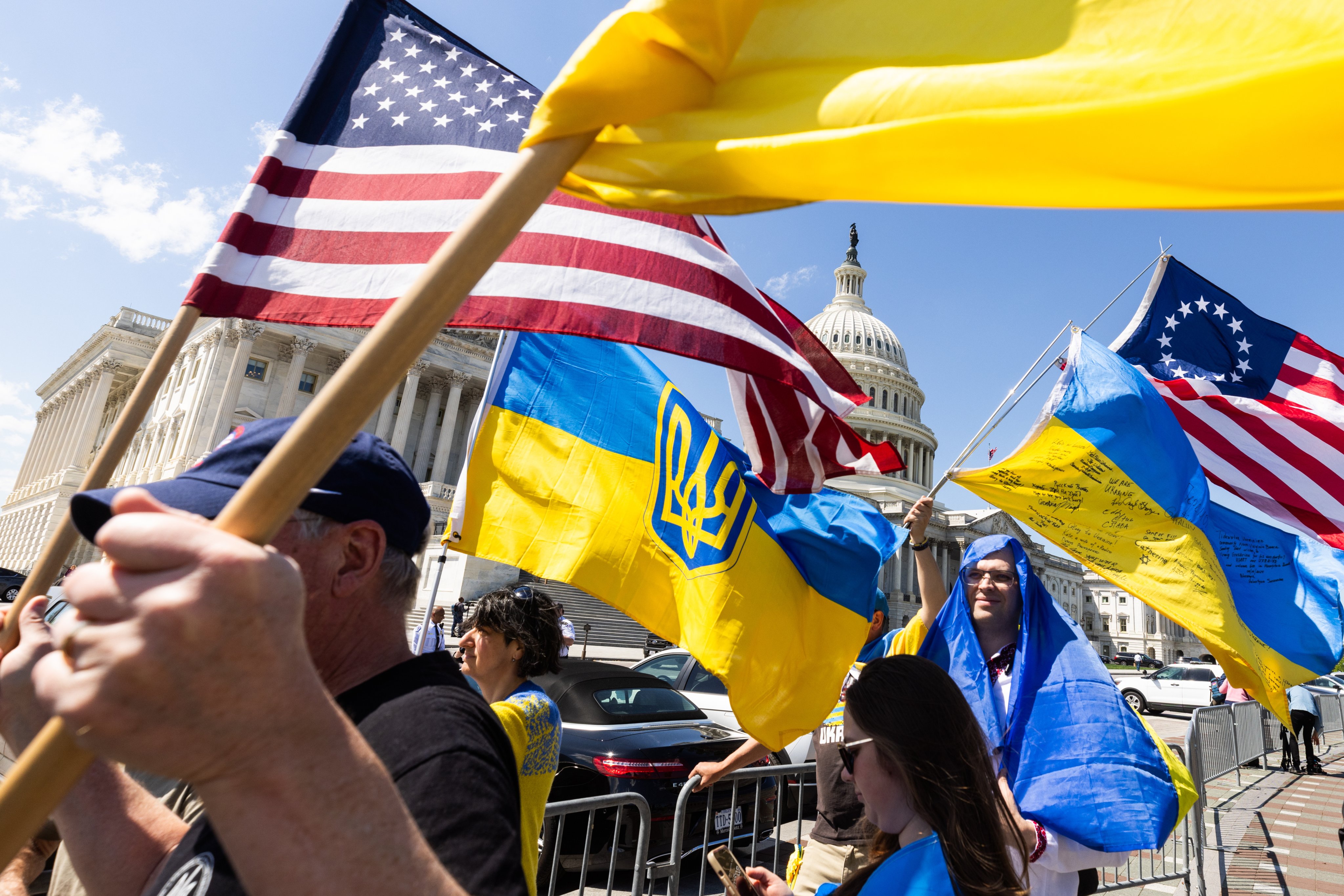 Supporters wave US and Ukrainian flags outside the Capitol in Washington after the House approved foreign aid packages to Ukraine, Israel and Taiwan on Saturday. Photo: EPA-EFE