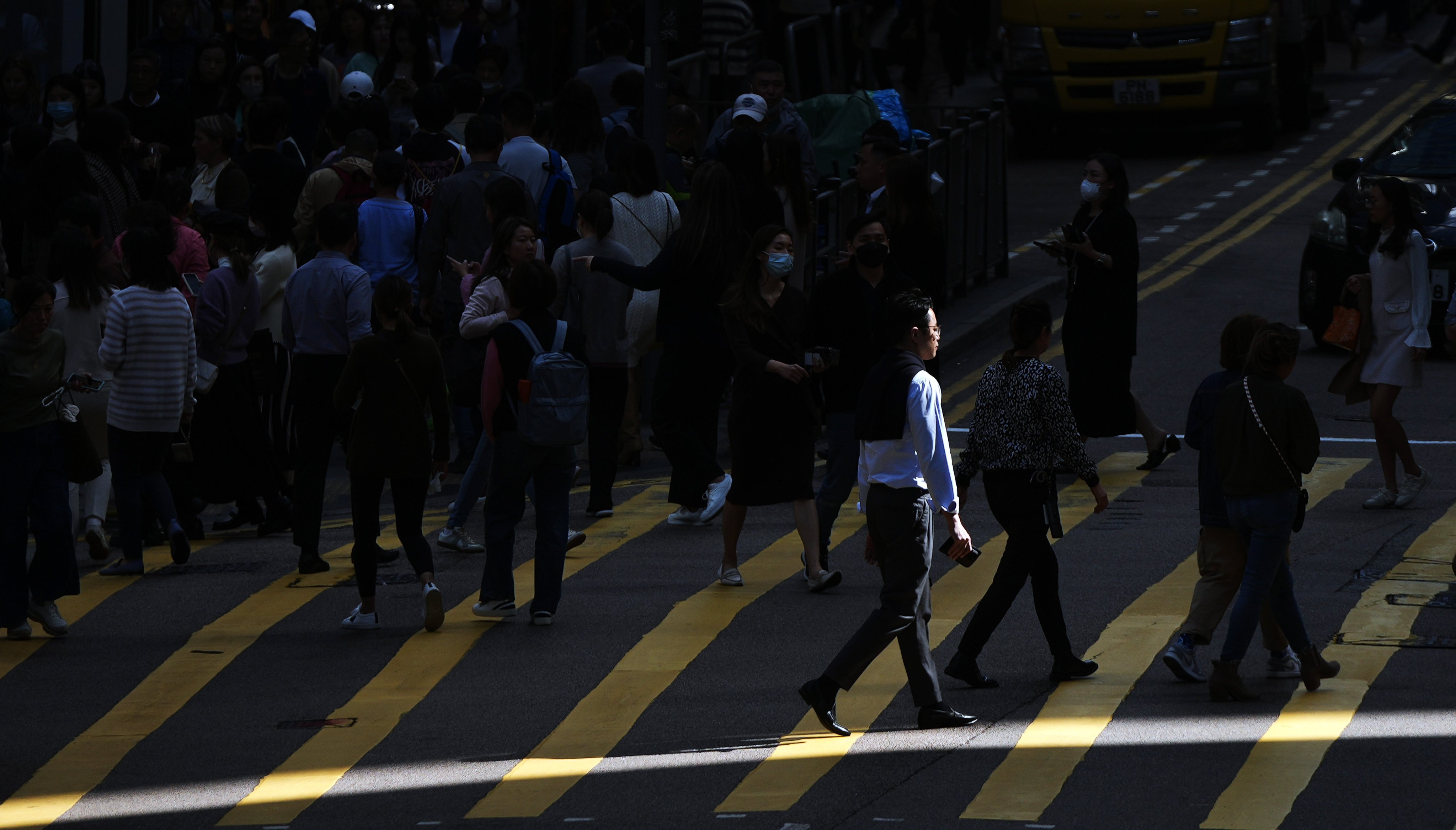 Pedestrians in Central. One expert has called for government incentives to help company transition to new ways of working. Photo: Eugene Lee