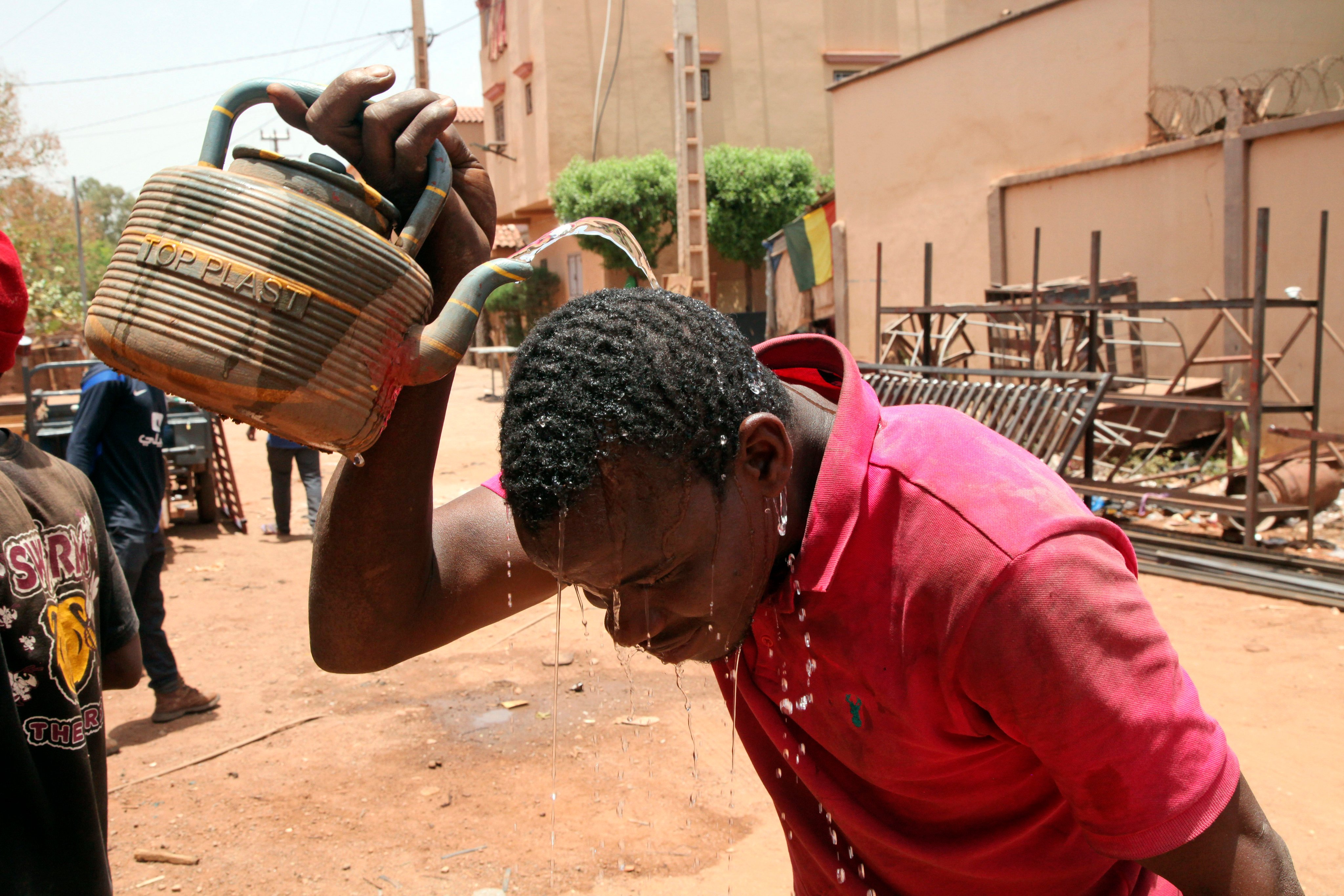 A man cools off with water under a blazing sun in Bamako, Mali, on April 18. Photo: AP