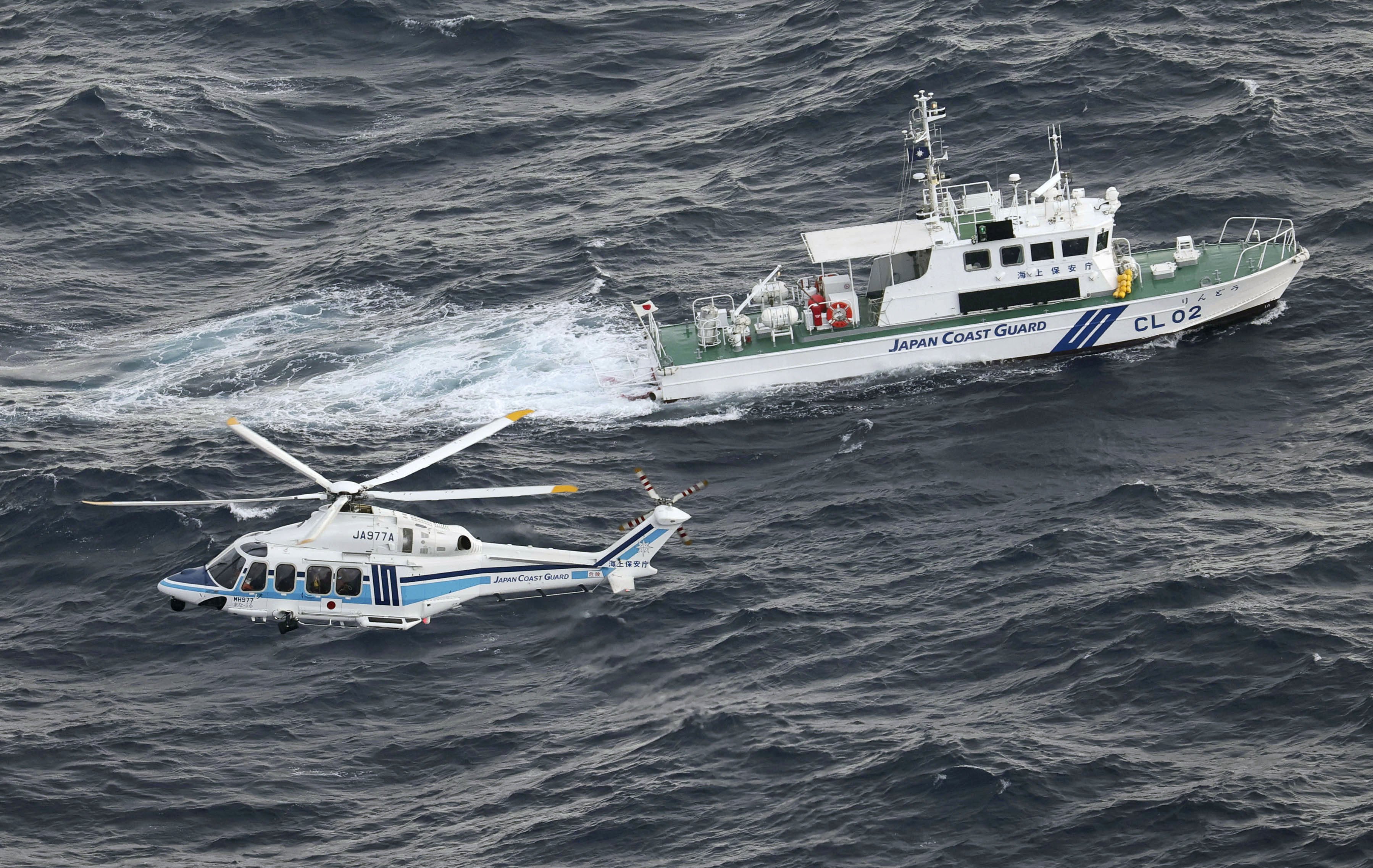 A Japan Coast Guard patrol ship and helicopter take part in a search and rescue mission in November. Photo: Kyodo