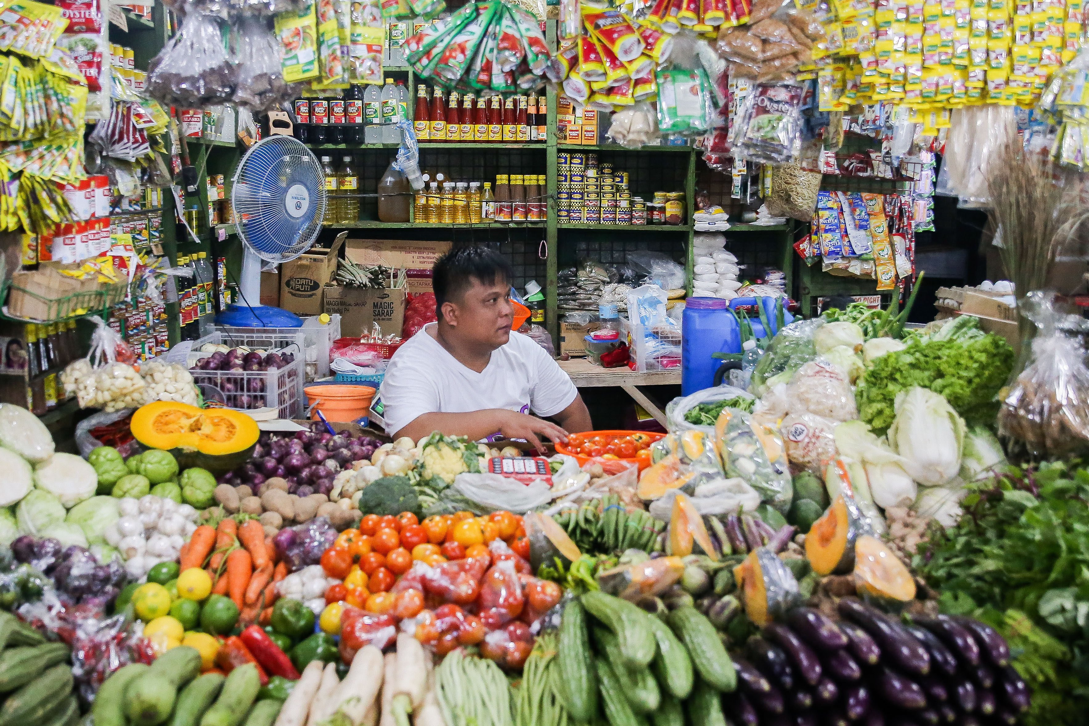 A vendor waits for customers inside his stall at a market in Quezon City, the Philippines. Photo: Xinhua