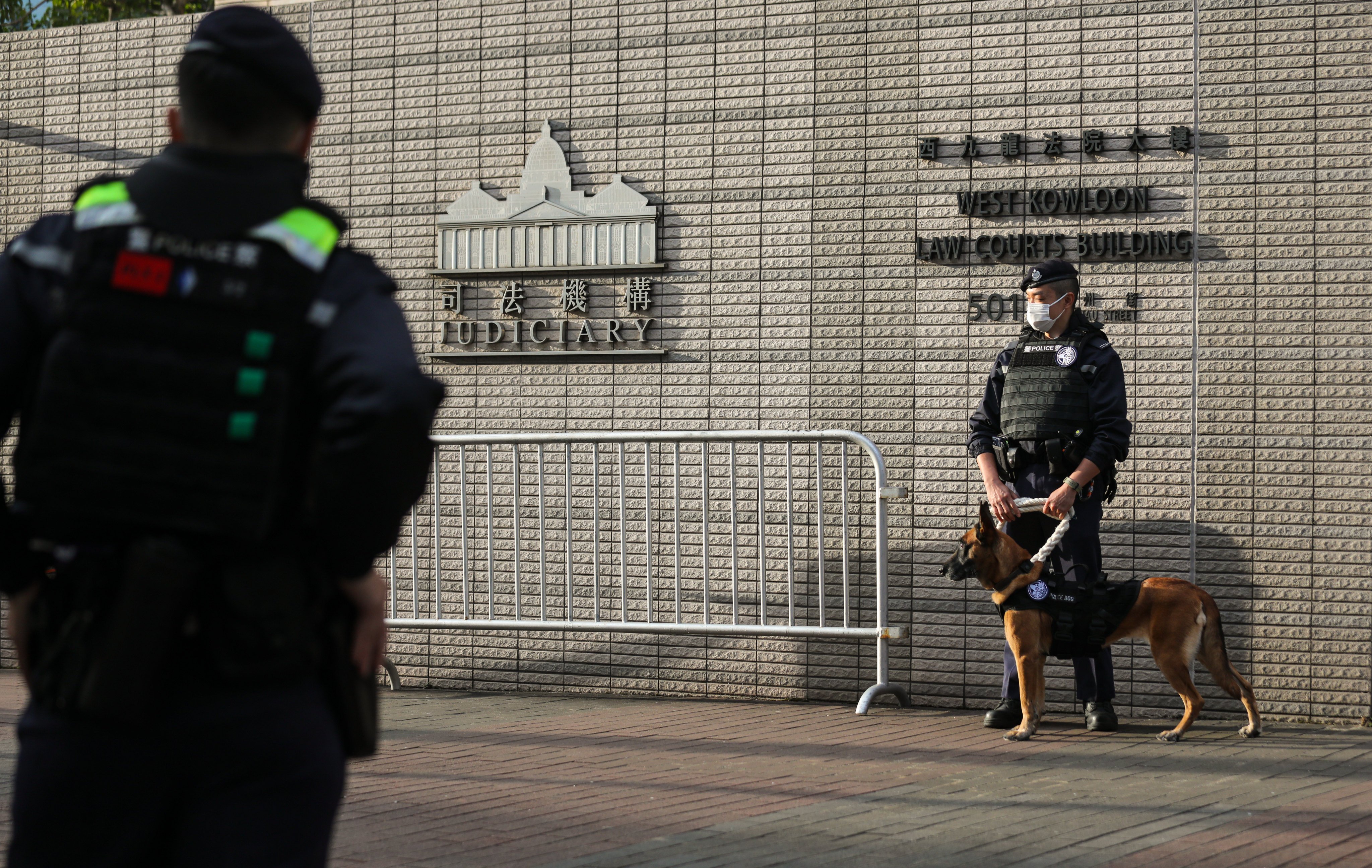 Police officers patrol outside West Kowloon Court amid Jimmy Lai’s ongoing national security trial. Photo: Xiaomei Chen
