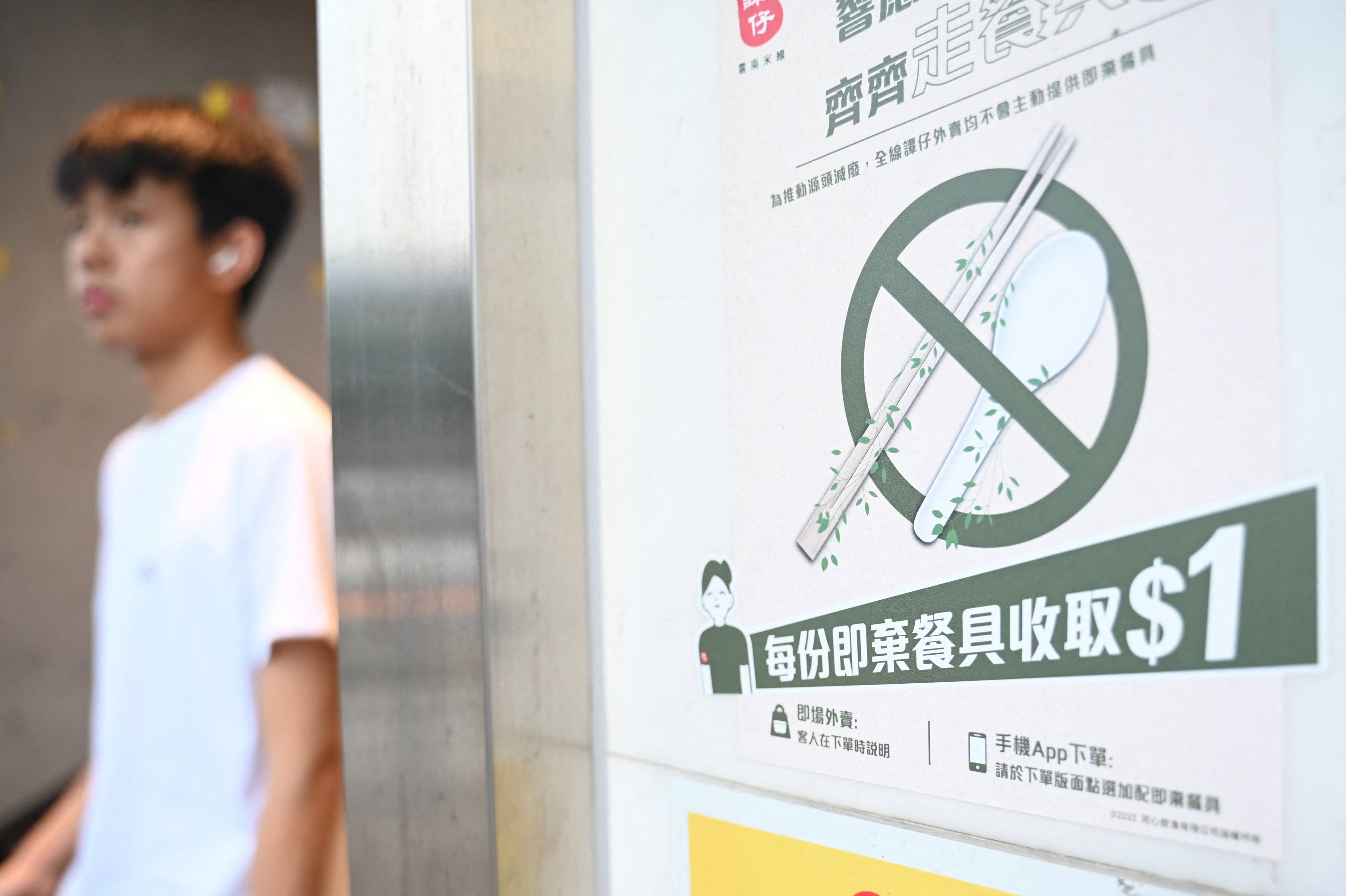 A sign at a restaurant informs patrons that it will not supply single-use plastic utensils to customers in Hong Kong, starting on April 22, as the city enforces the first phase of a ban on disposable plastic products in restaurants and hotels. Photo: AFP