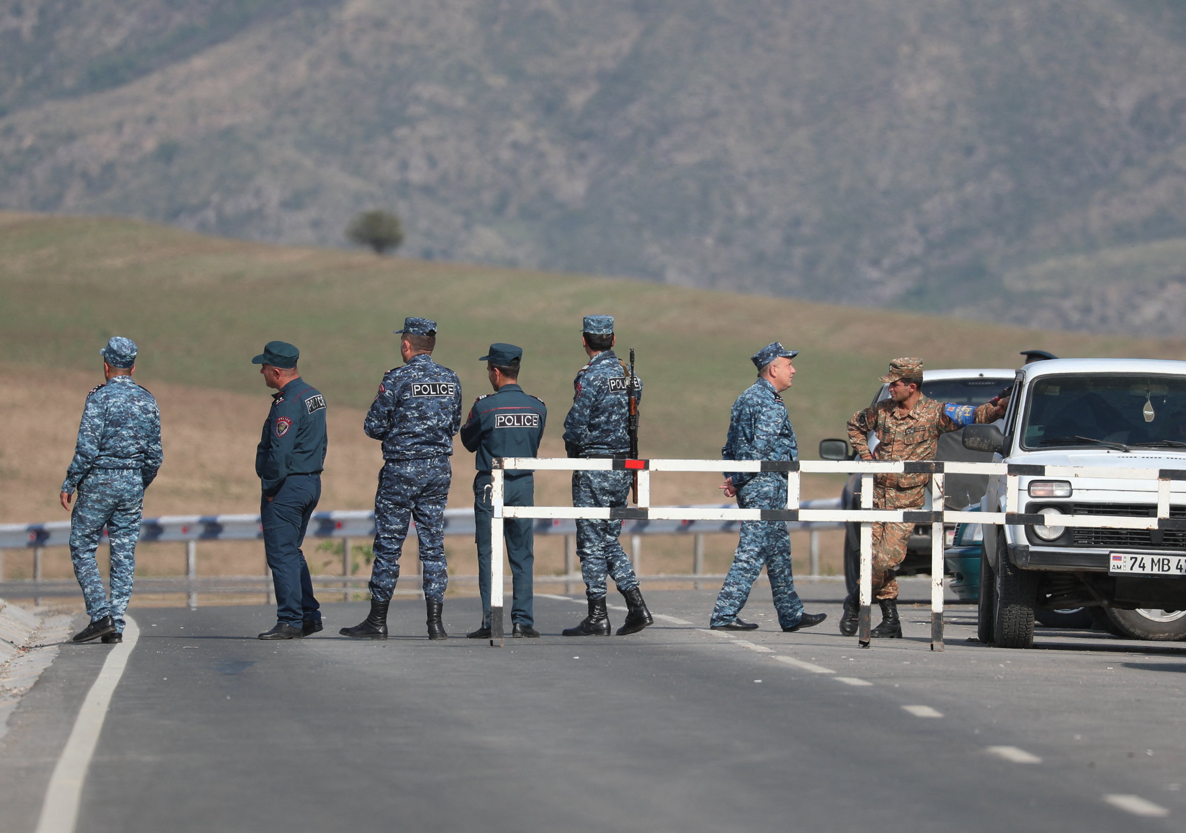 Armenian officers stand at a checkpoint leading to Azerbaijan’s Nagorno-Karabakh region. The neighbours have begun fixing their border, as part of normalisation efforts following a decades-long territorial conflict. Photo: Reuters