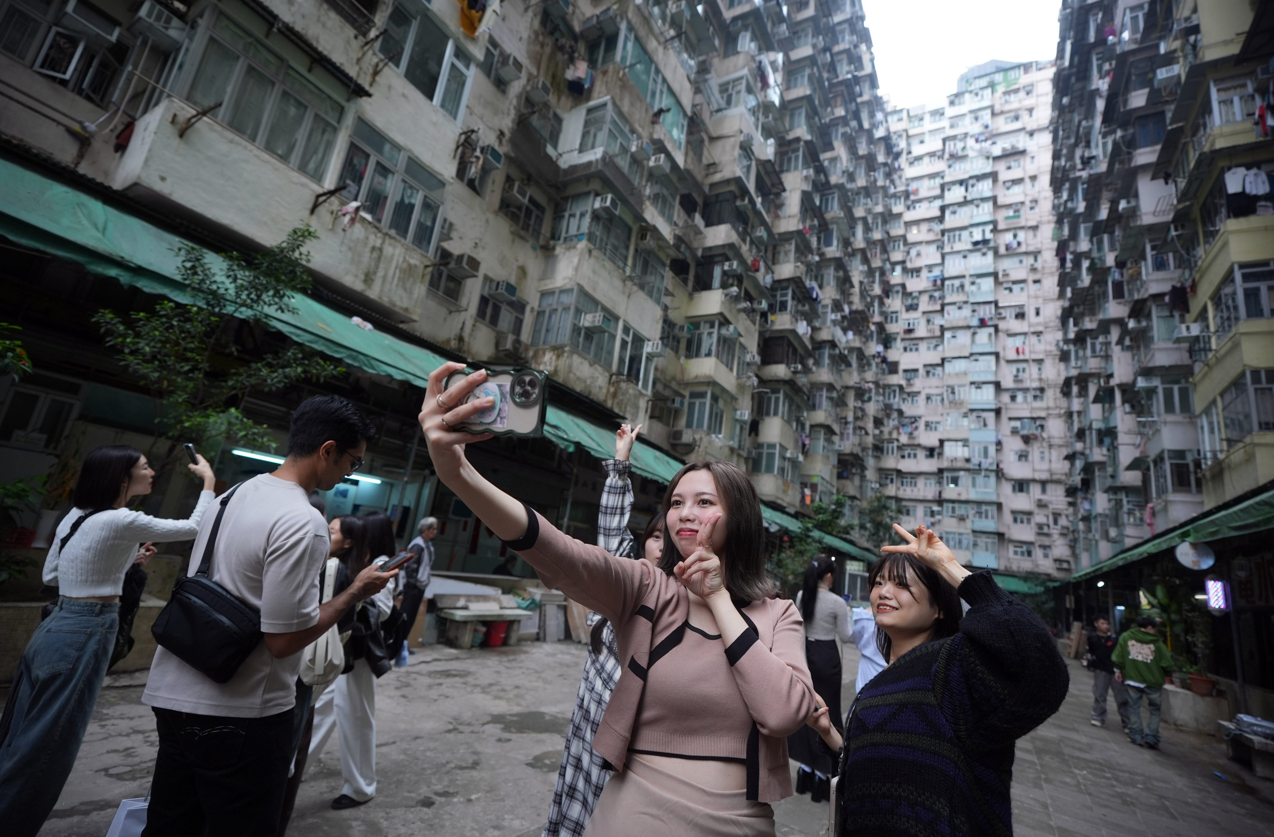 Tourists take pictures of the Instagram-famous Yick Cheong Building, popularly know as the ‘Monster Builidng’, in Quarry Bay. Photo: Eugene Lee