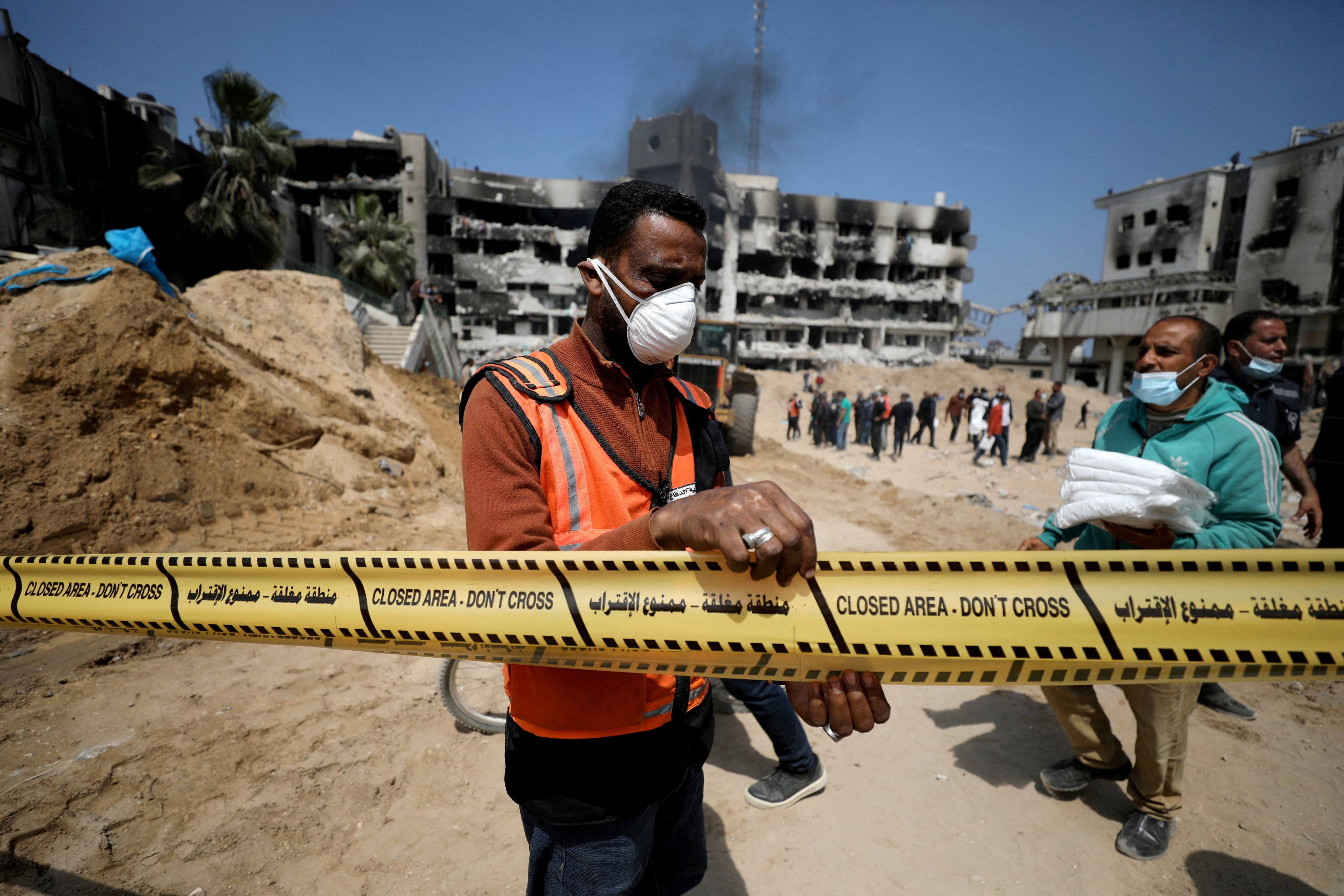 A man tapes off the area as rescuers and medics search for dead bodies inside the damaged al-Shifa Hospital. Photo: Reuters