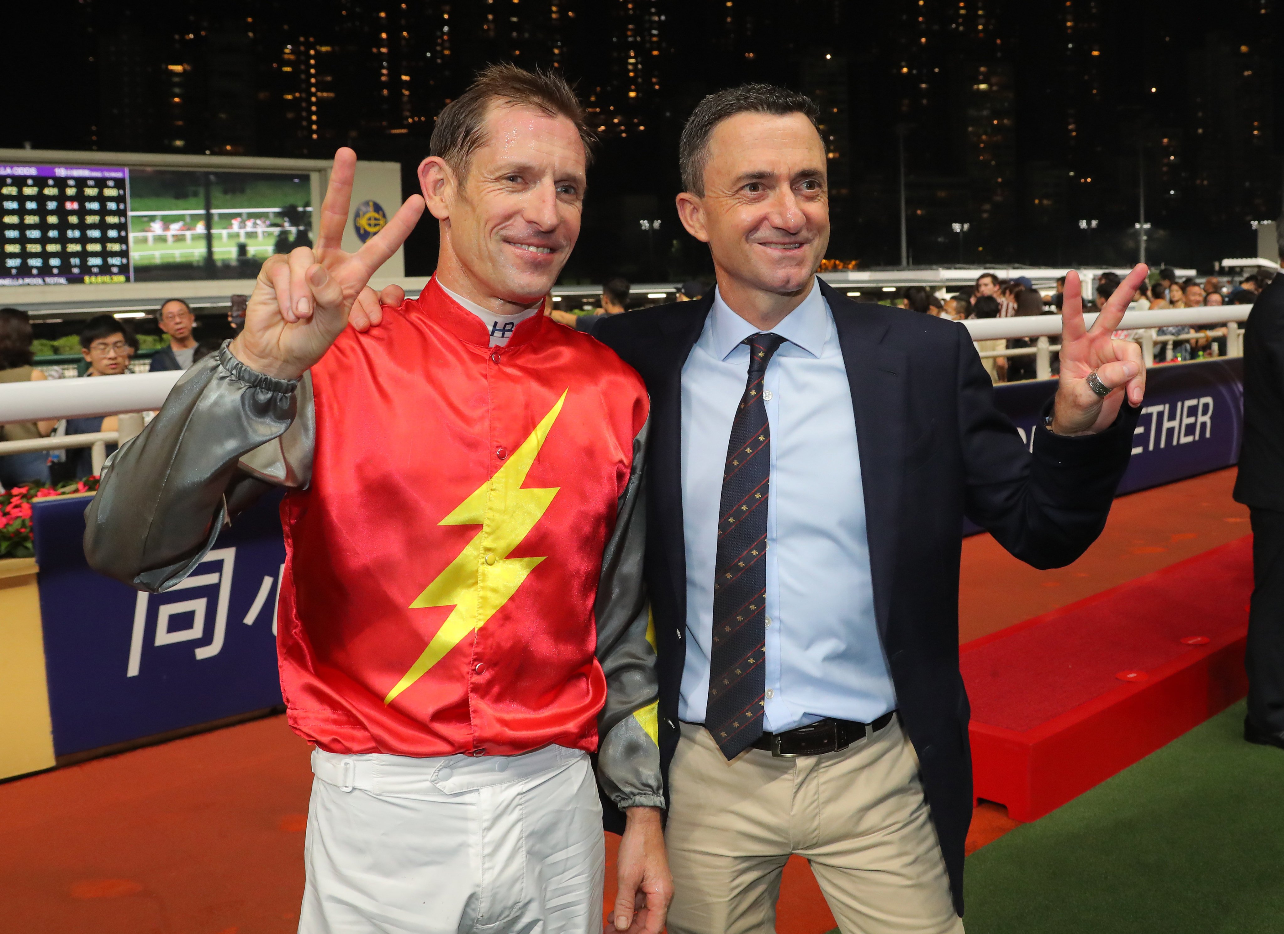 Douglas Whyte celebrates his 200th win as a trainer with Hugh Bowman after Majestic Knight’s Happy Valley triumph. Photos: Kenneth Chan