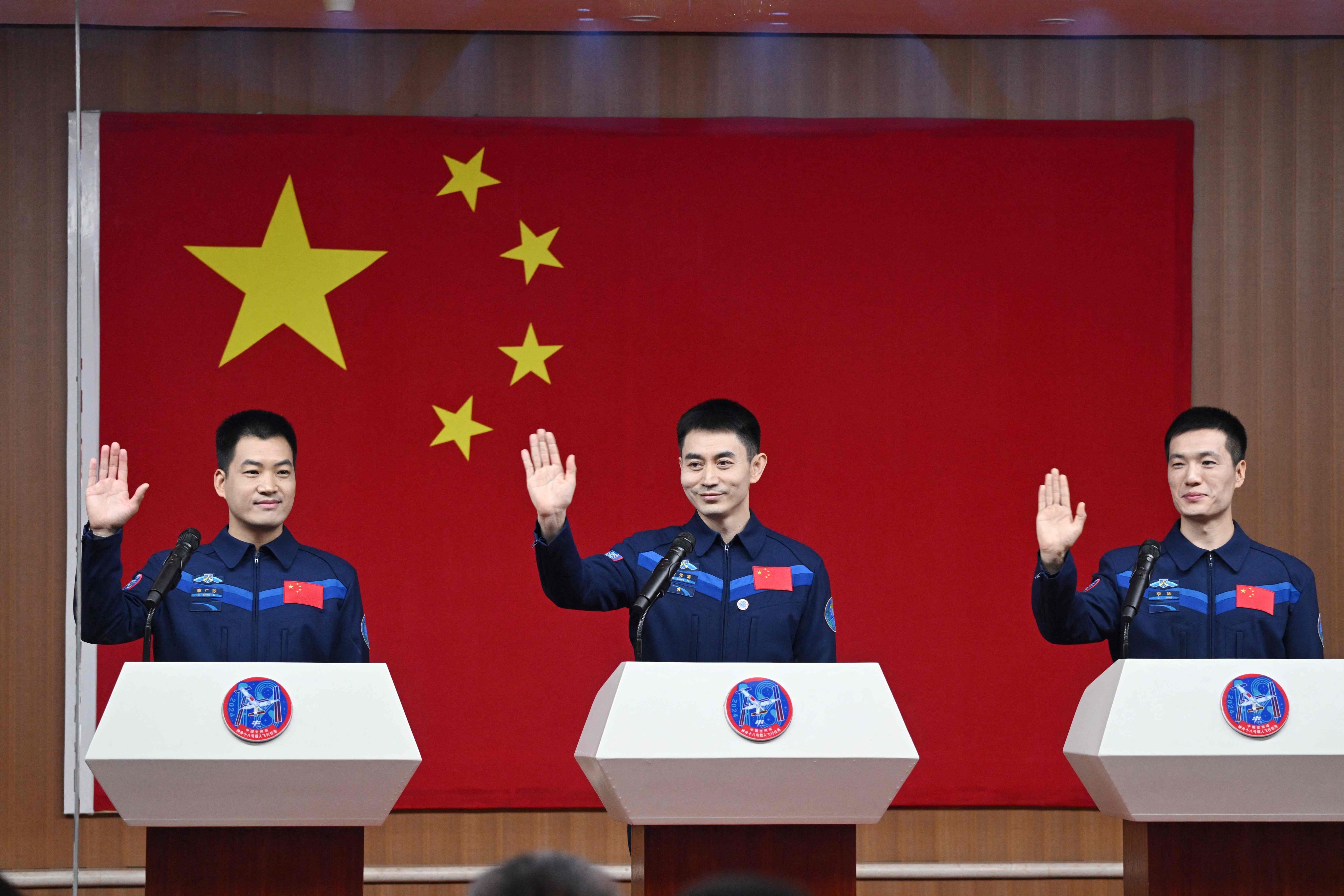 Shenzhou-18 crew members (from left to right) Li Guangsu, Ye Guangfu and Li Cong wave during a press conference at the Jiuquan Satellite Launch Centre in northwest China on April 24. Photo: AFP