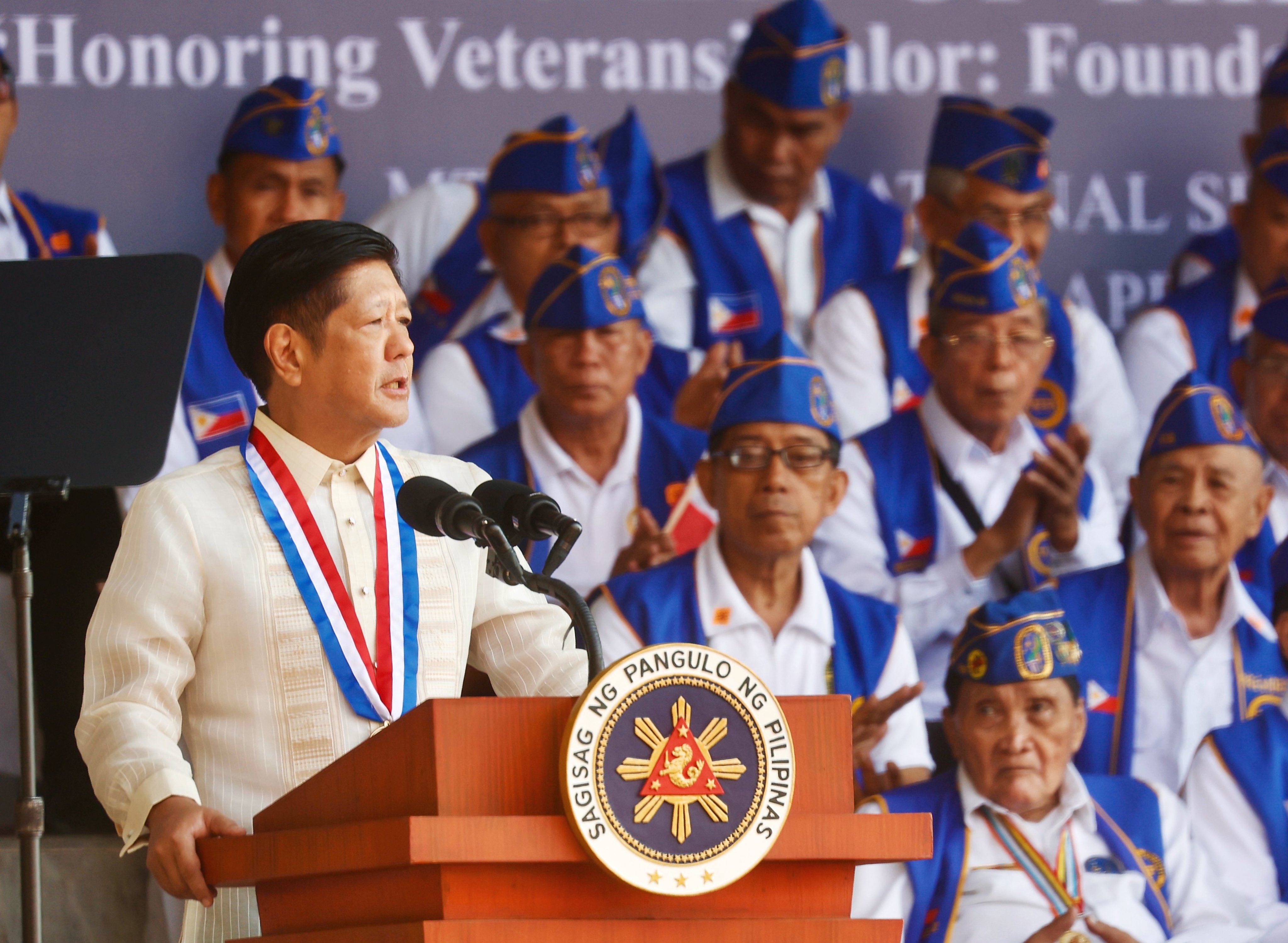 Philippine President Ferdinand Marcos Jnr speaks next to Filipino veterans in Bataan province earlier this month. Photo: EPA-EFE