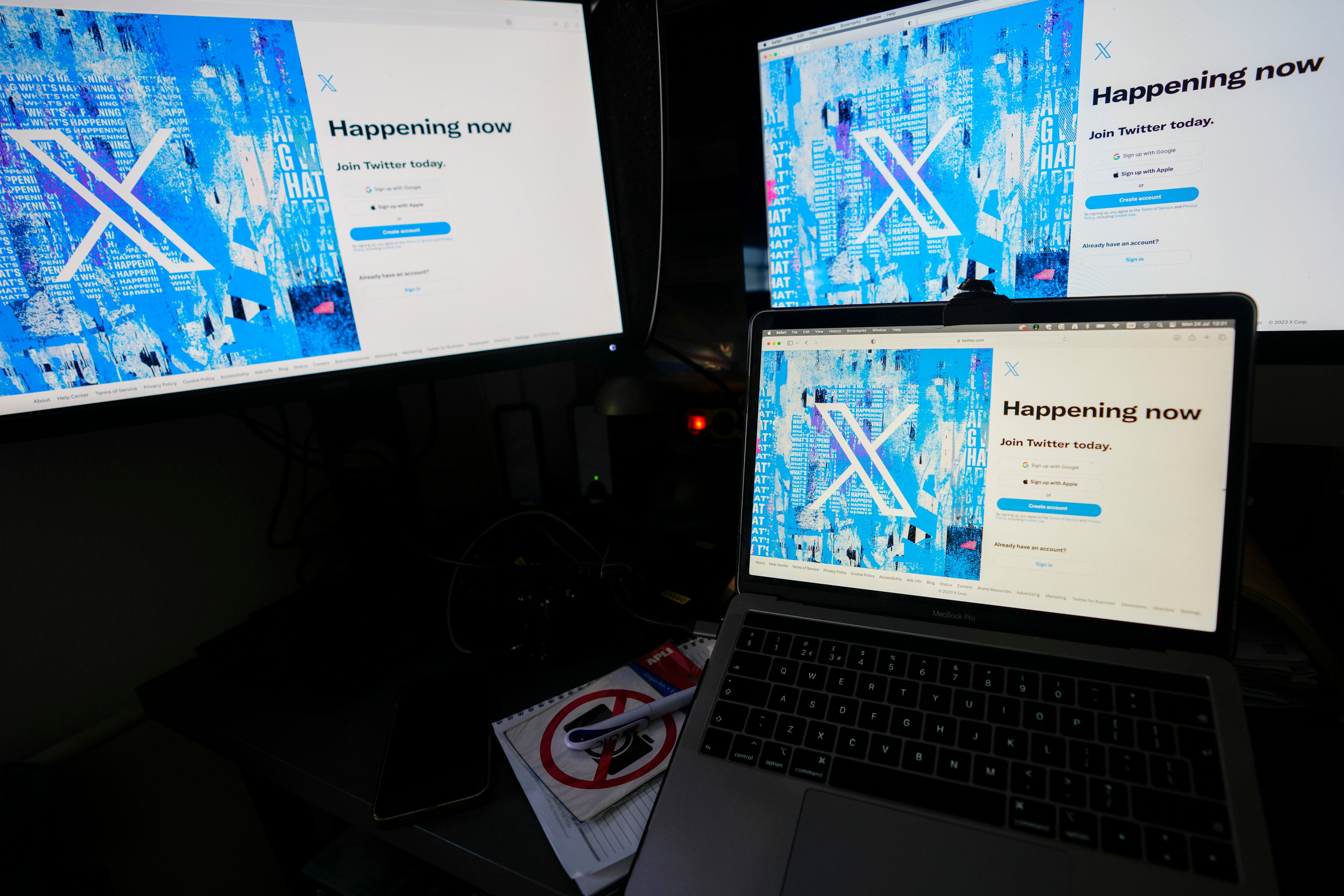 Computer monitors display the sign-in page for X, formerly known as Twitter. Photo: AP