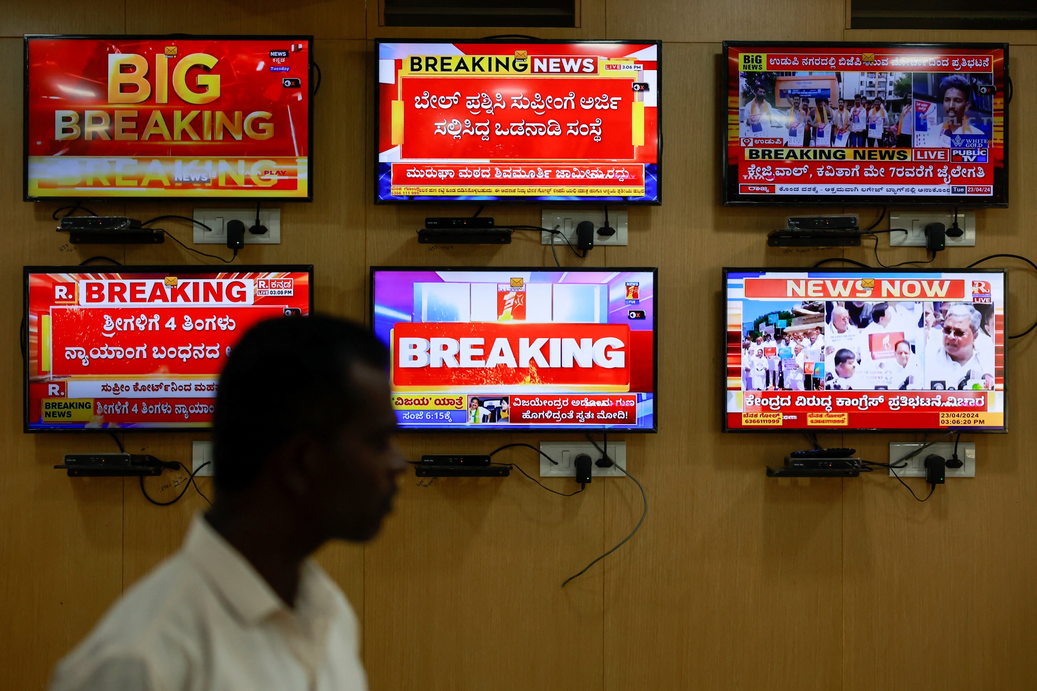 An official in front of TV screens inside a media monitoring room in Bengaluru, Karnataka, ahead of India’s general election. Photo: Reuters