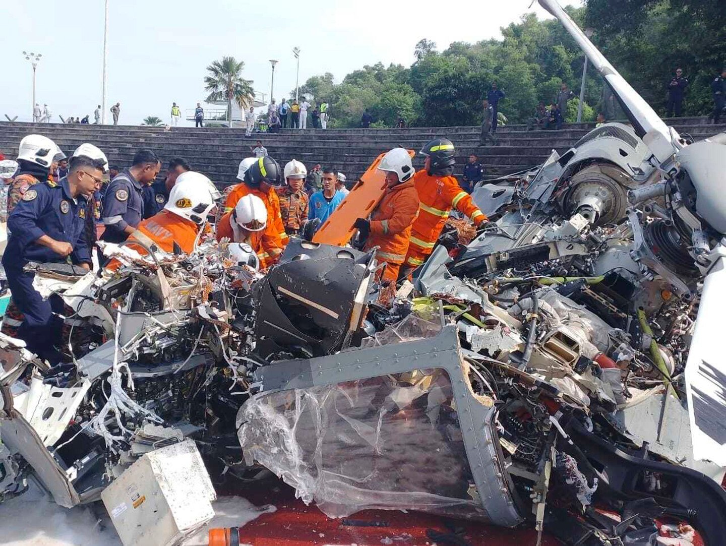 Rescue personnel inspect the crash site of two helicopters in Lumur, Perak, on April 23. Photo: Fire & Rescue Department of Malaysia via AP