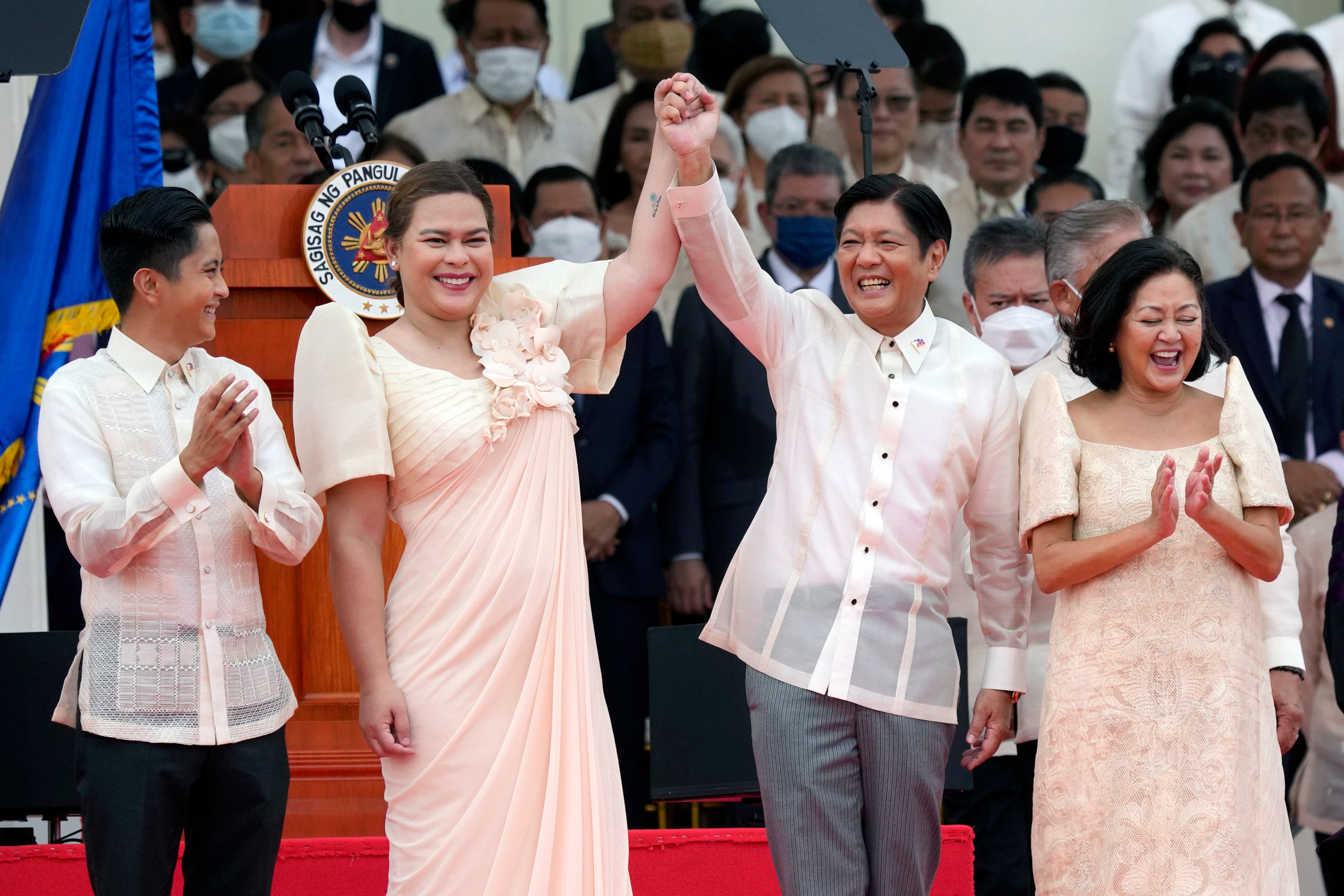Philippine President Ferdinand Marcos Jnr, standing beside first lady Liza Marcos, holds hands with Vice President Sara Duterte, daughter of former Philippine President Rodrigo Duterte, at their inauguration ceremony on June 30, 2022 in Manila. Photo: AP