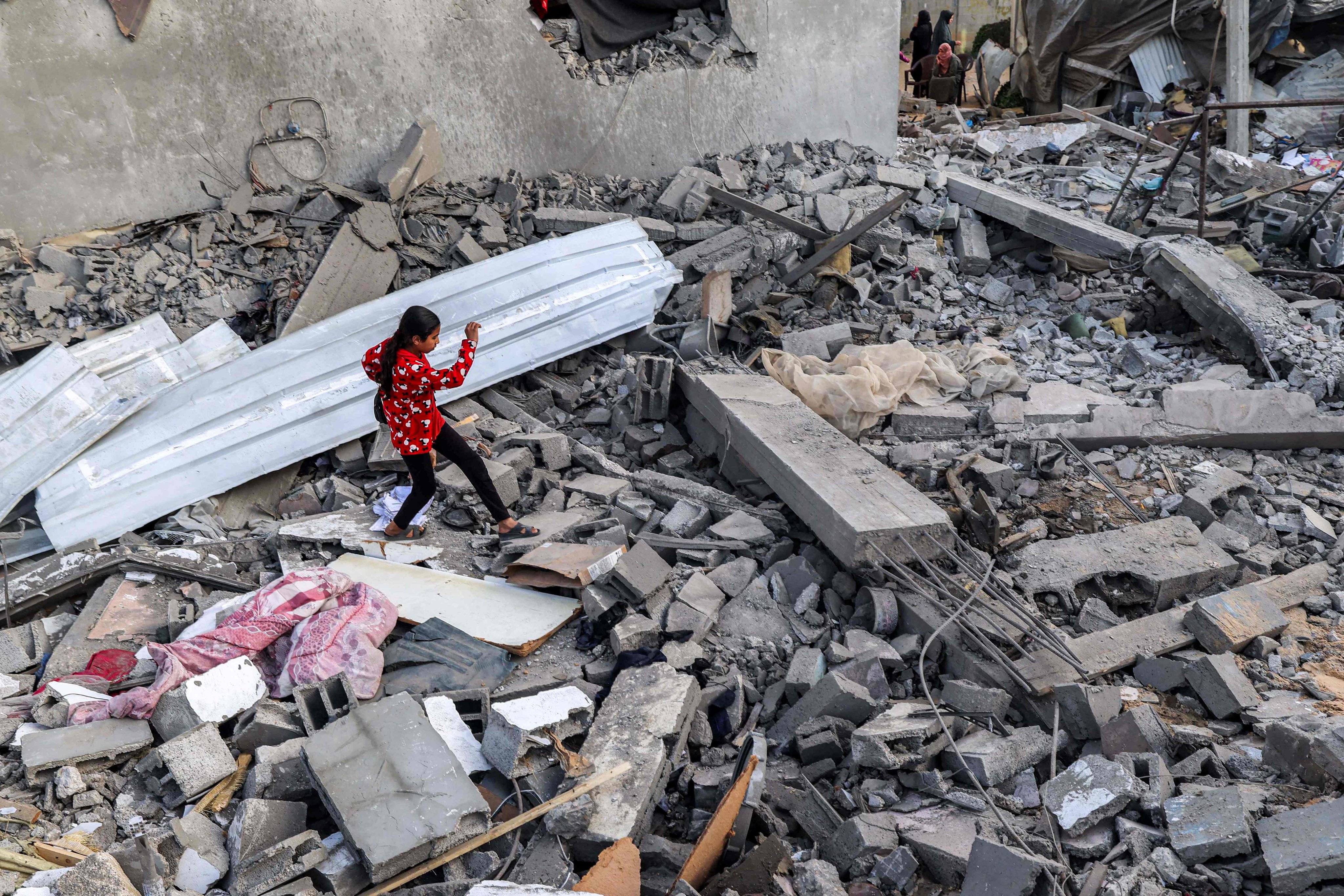 A girl walks through rubble in Rafah in the southern Gaza Strip following reported Israeli air strikes. Photo: AFP