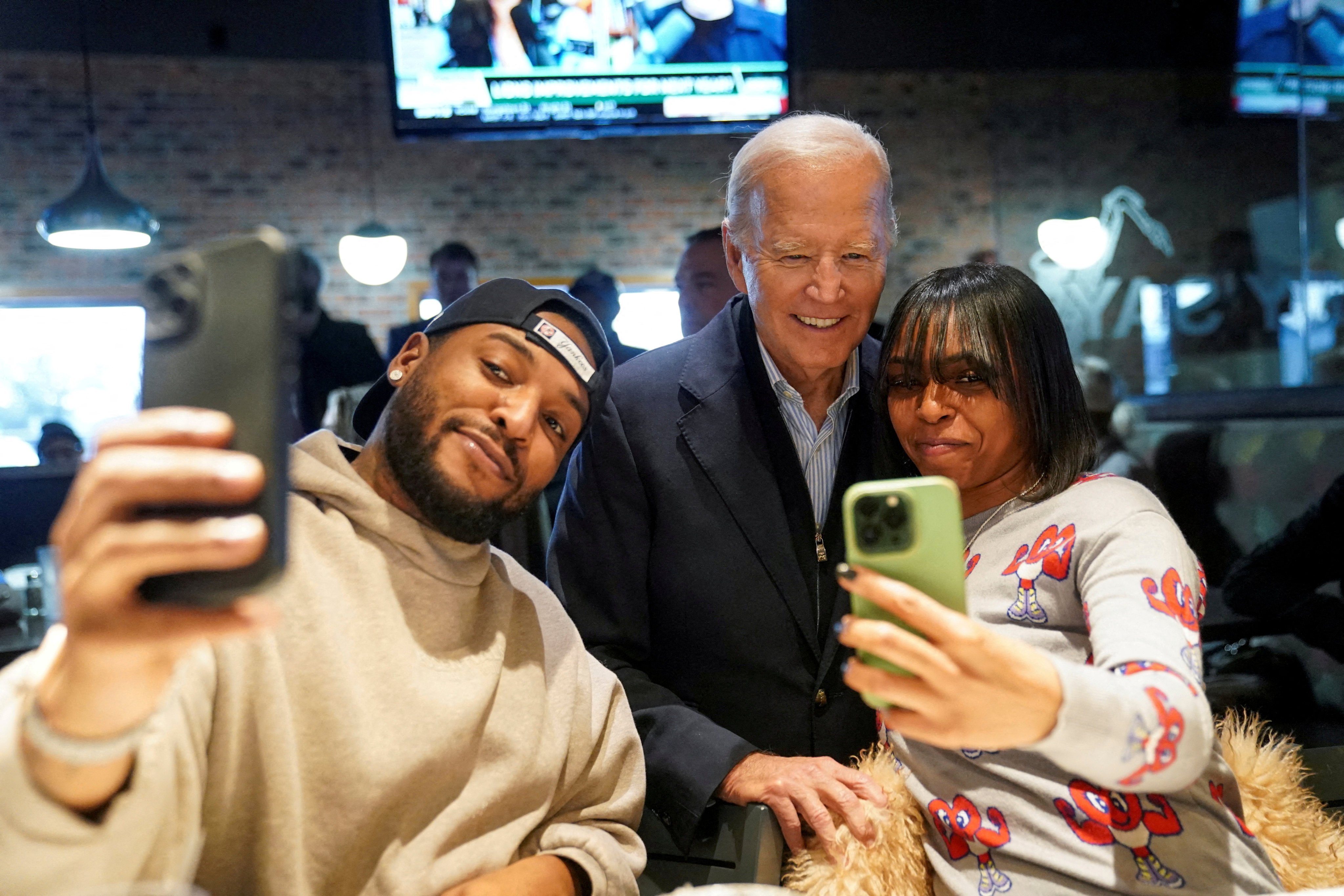 US President Joe Biden poses for a selfie with diners in Detroit, Michigan, in February. File photo: Reuters