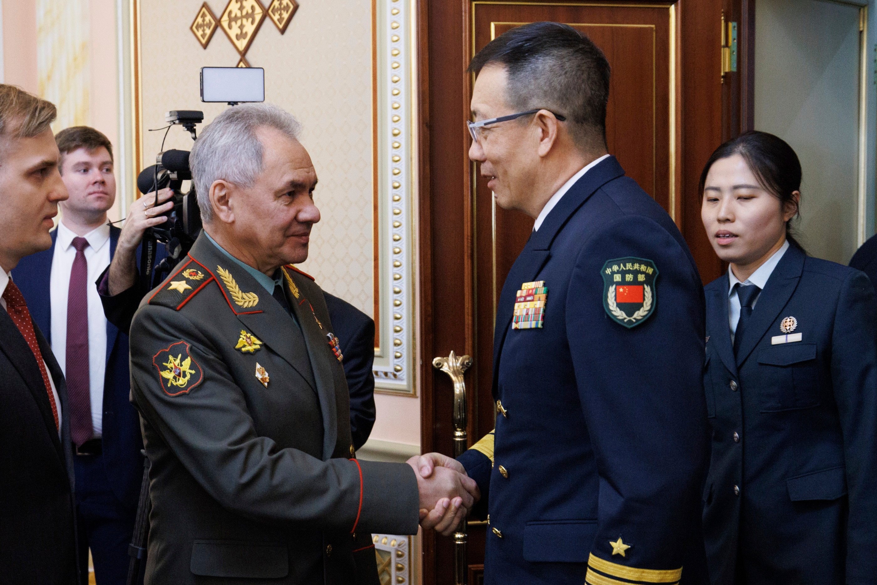 Russian Defense Minister Sergei Shoigu (left) greets Minister of National Defence of the People’s Republic of China Dong Jun on the sidelines of the Shanghai Cooperation Organisation in Astana, Kazakhstan, on Friday. Photo: Russian Defence Ministry Press Service via AP