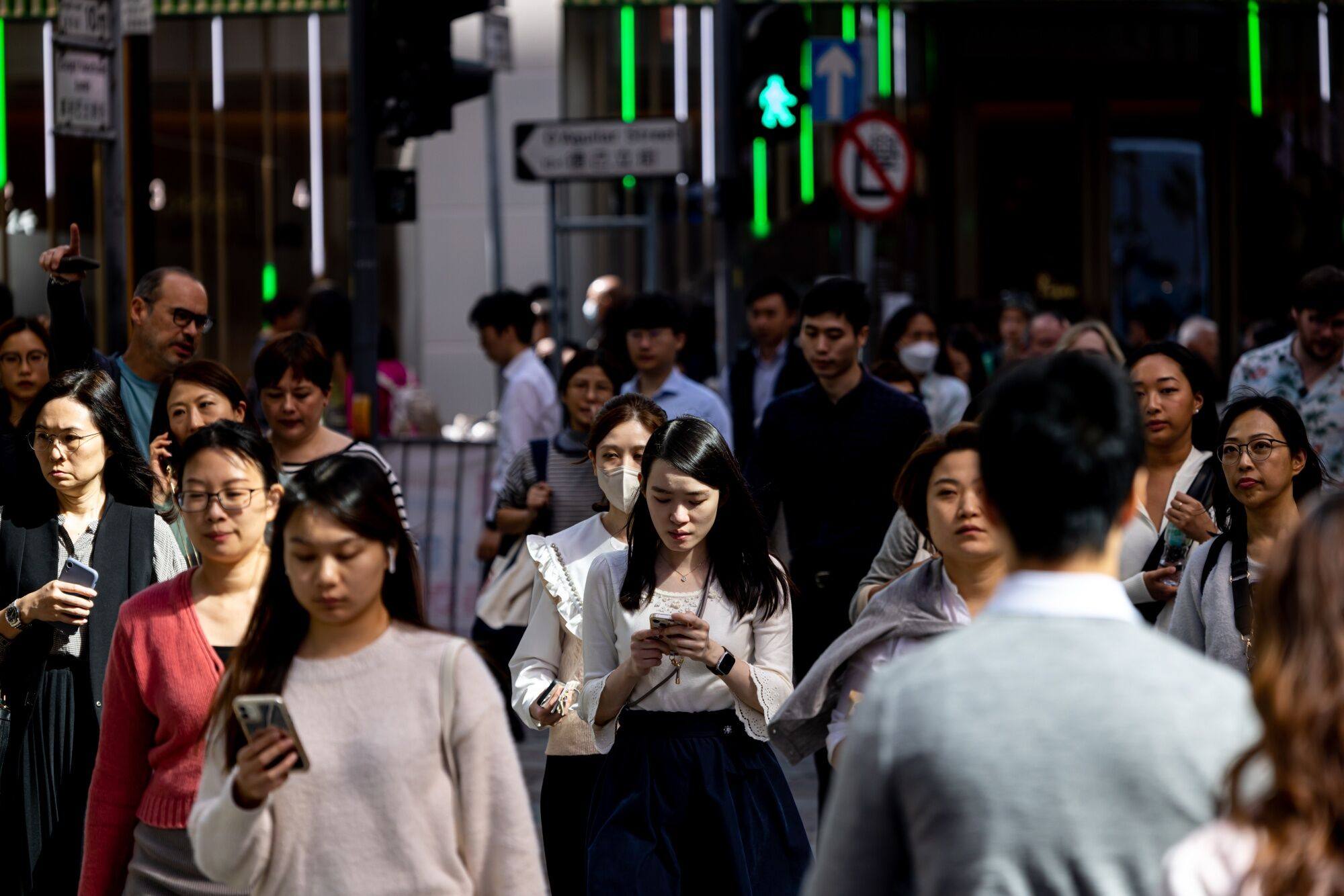 Office workers walk during lunch hour in Hong Kong’s Central district in 2023. While many workers in Hong Kong are embracing AI, they need training and a better understanding of the technology. Photo: Bloomberg