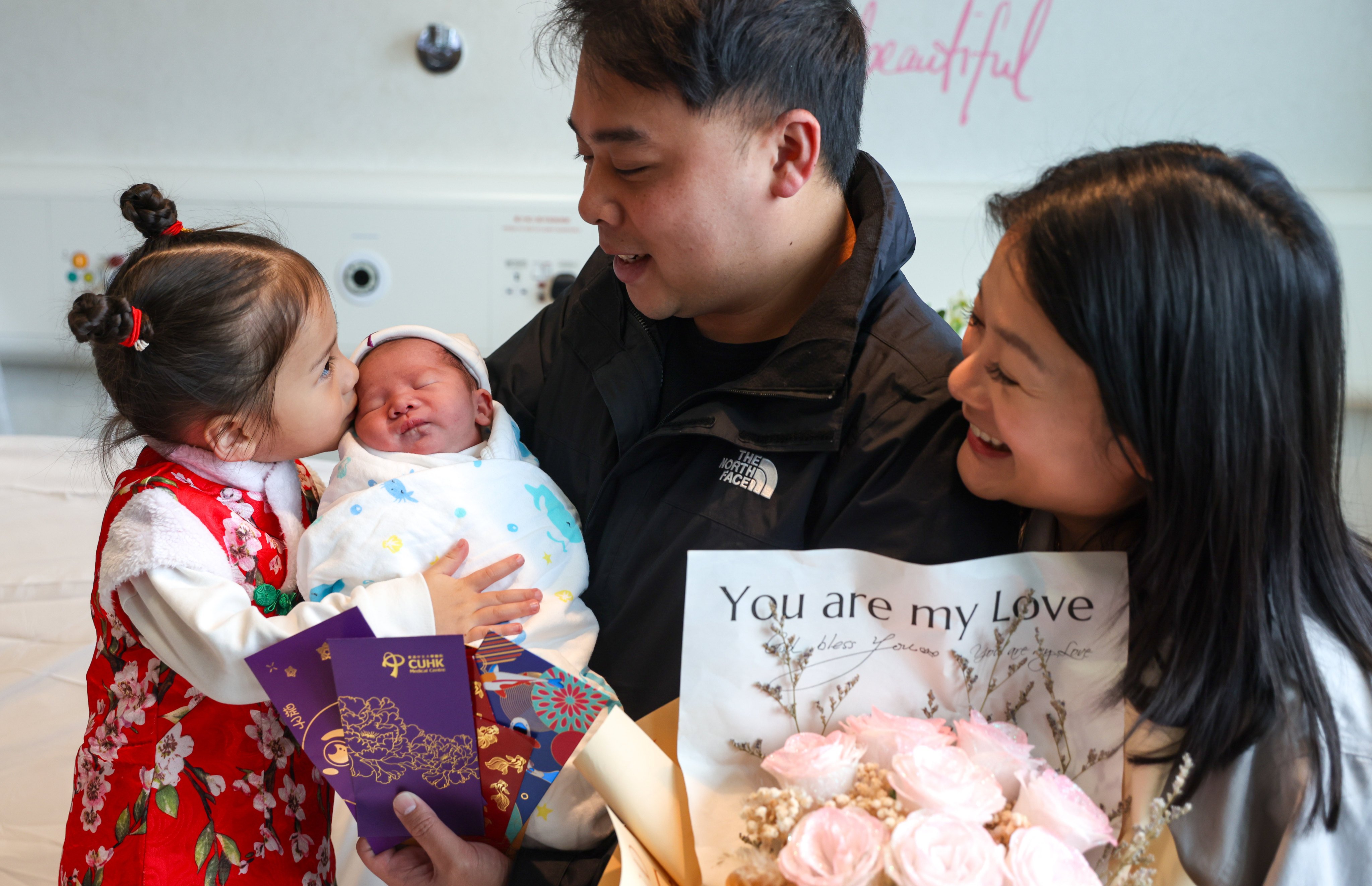 Kelvin Chan, his wife Judy Lo and their daughter Leah welcome the newest member of their family, Miles, at the CUHK Medical Centre in Sha Tin on February 10. Photo: Yik Yeung-man