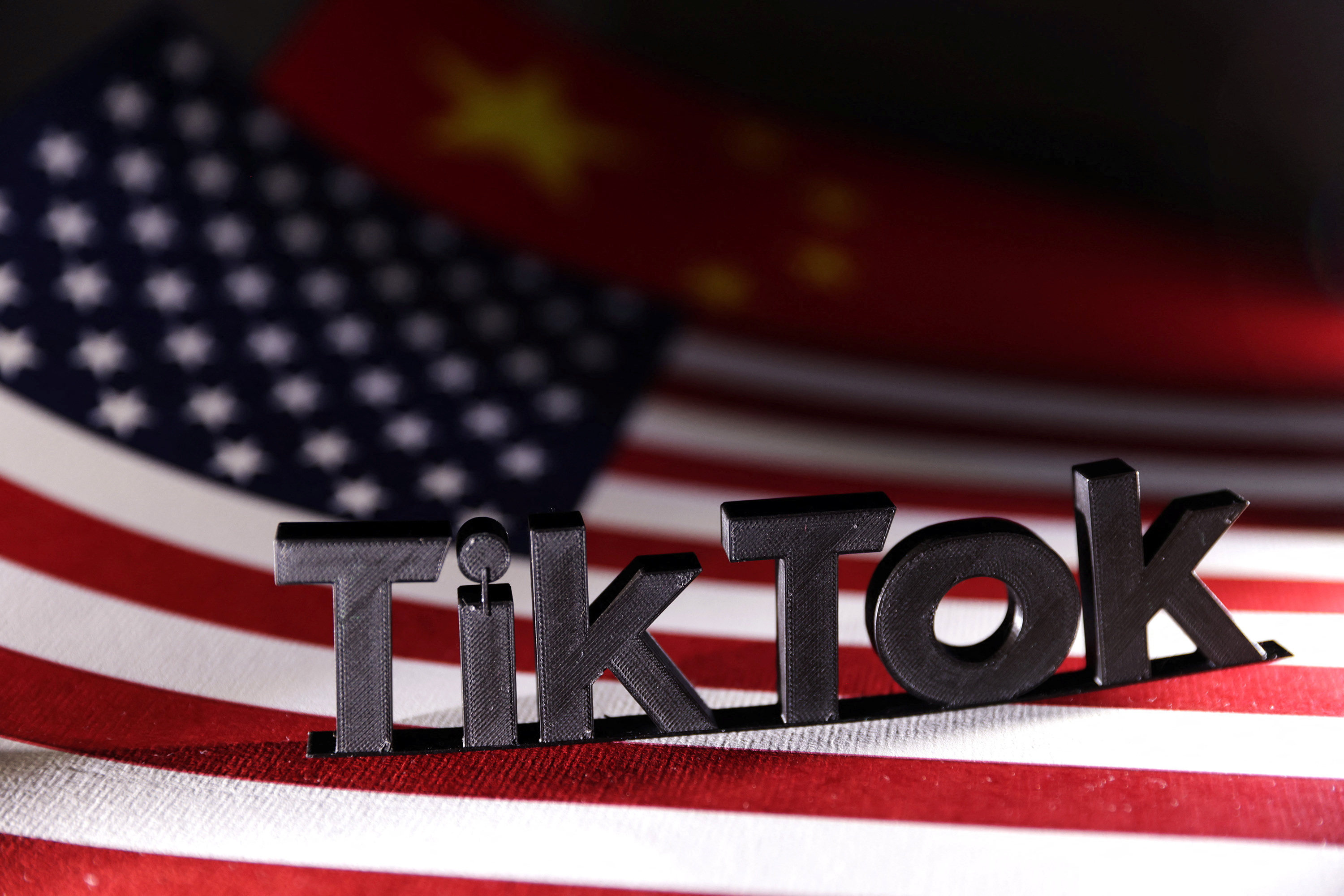 TikTok logo placed on the U.S. and Chinese flags. Photo: Reuters