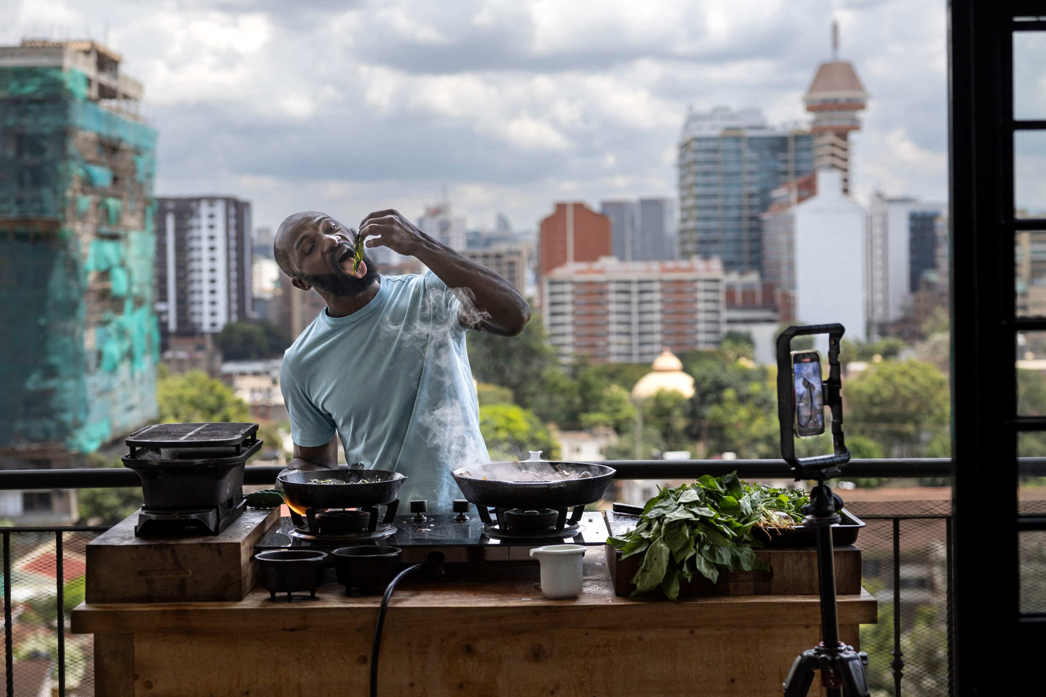 Former Kenya rugby sevens star Dennis Ombachi on the set of his cooking videos featuring his famous balcony with the Kenyan capital, Nairobi, in the background. Photo: AFP