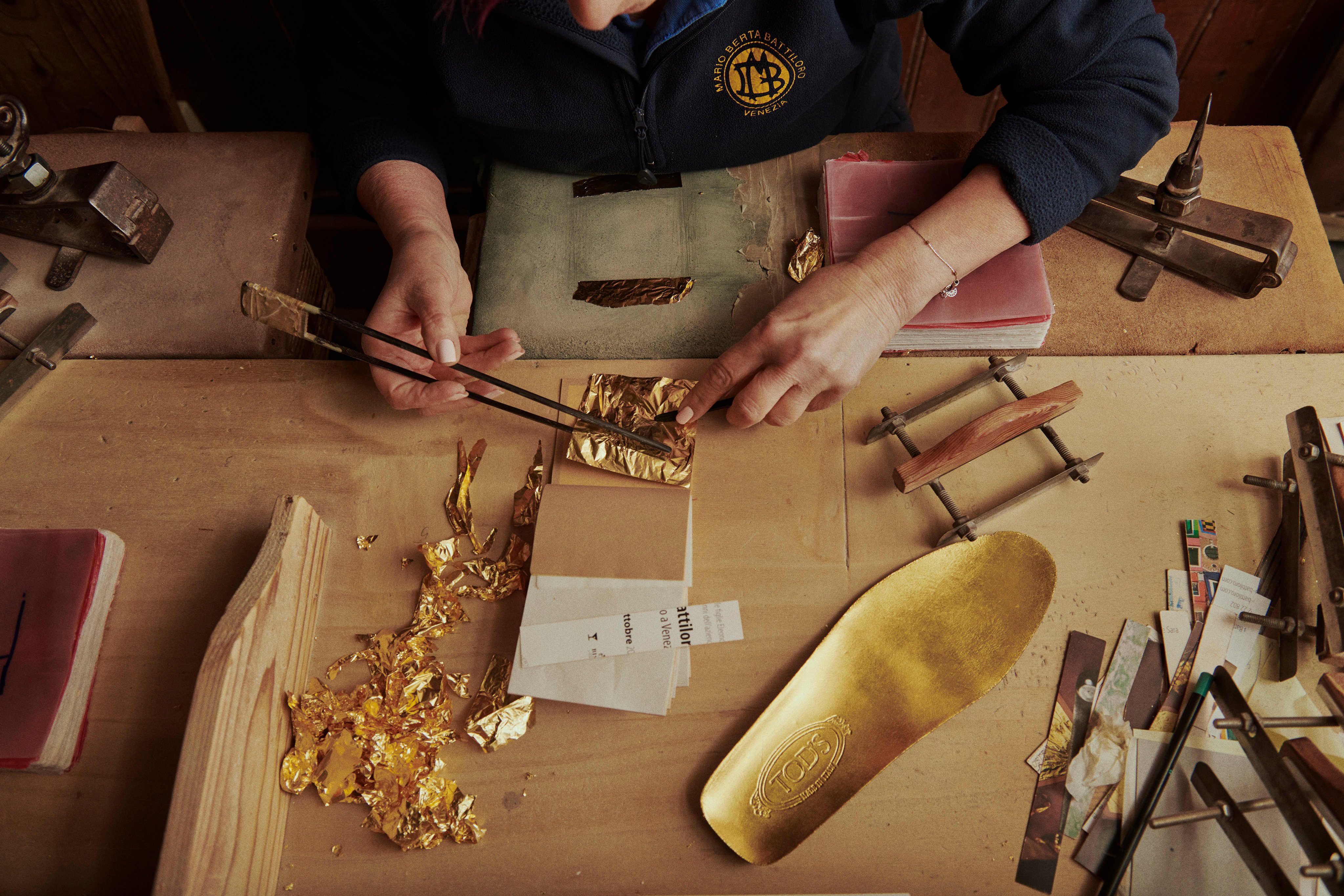 Goldbeating artisans Marino Menegazzo and Mario Berta Battiloro gilded a pair of Gomminos with gold leaf. Photo: Tod’s