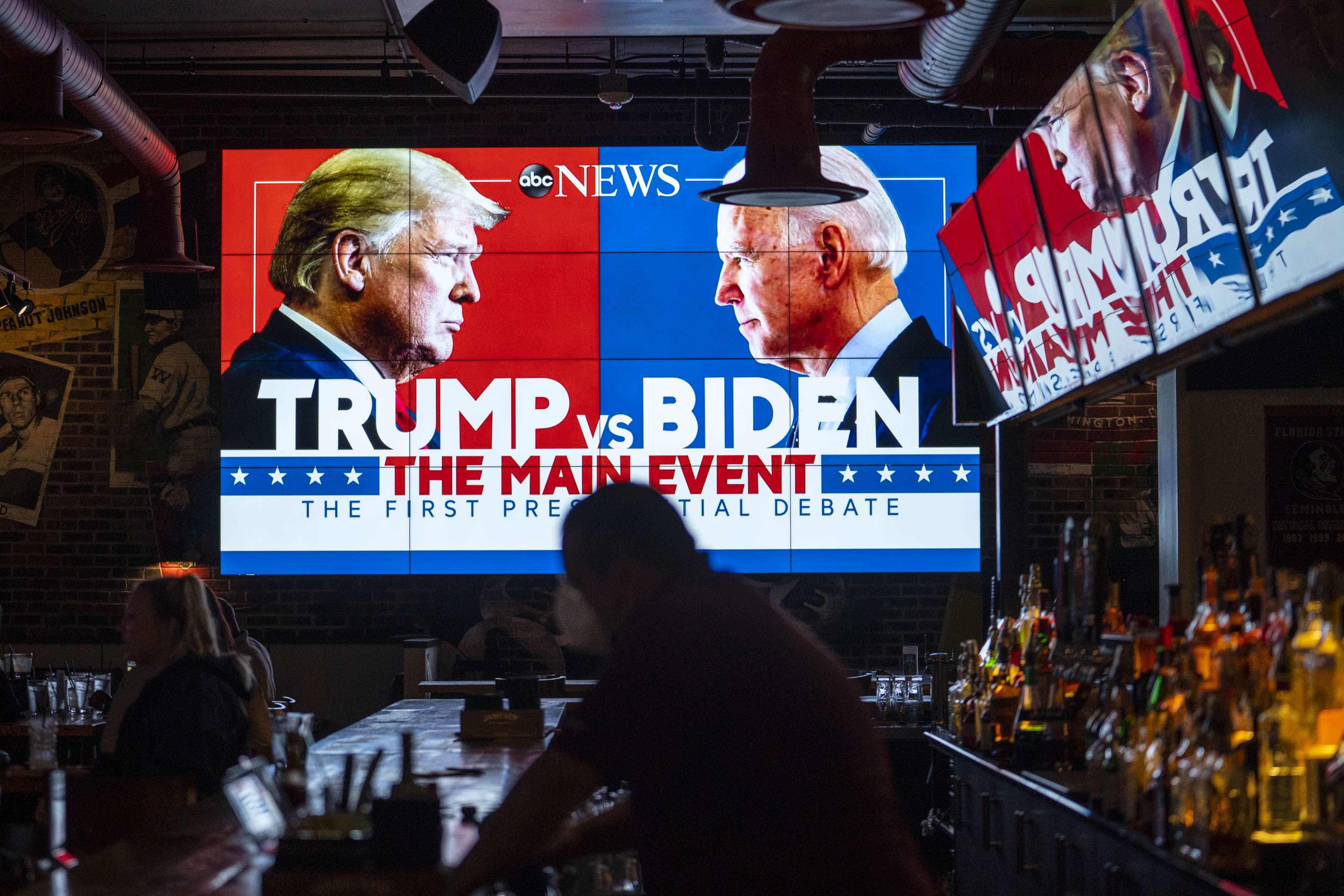 Television screens airing the first presidential debate are seen at a bar in Washington in September 2020. Photo: AFP