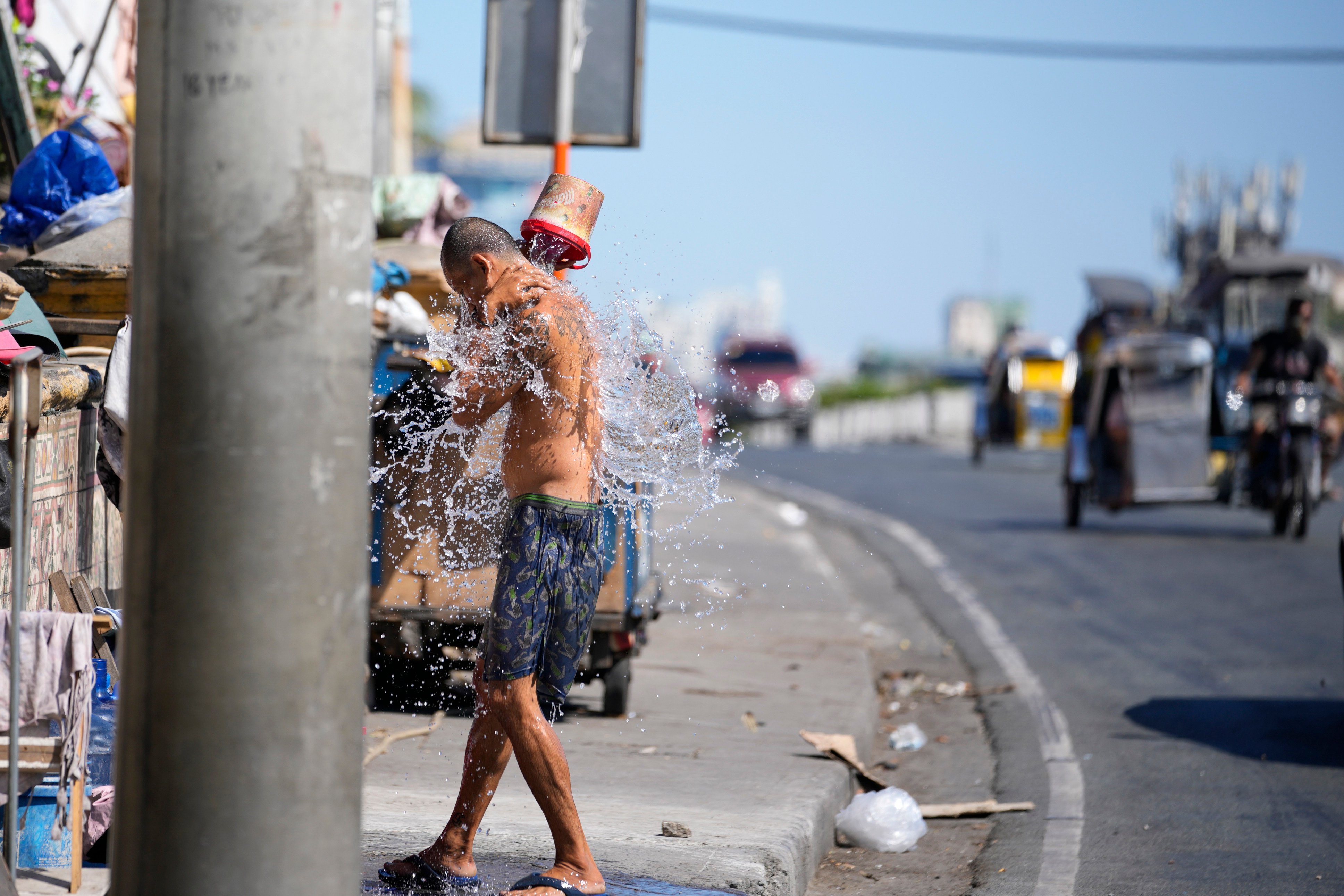 A man cools off in Manila in the Philippines. Parts of the country are experiencing extremely hot weather. Photo: AP